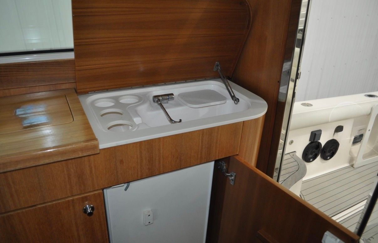 Interior of the 2005 Tiara Yachts 5200 Sovran with a small sink and storage area.