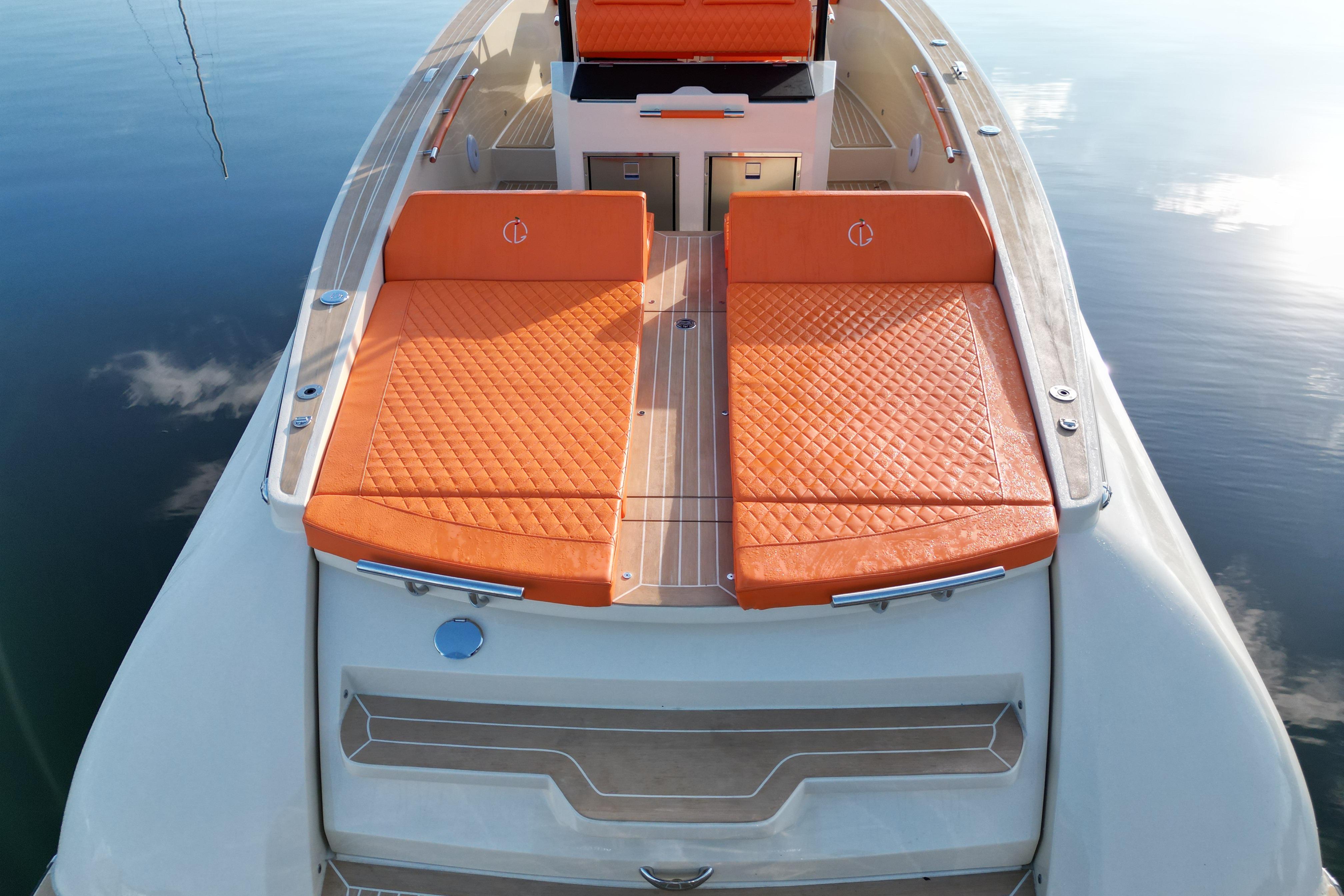 2026 Lilybaeum Lipari 31 yacht with orange quilted sunbeds on calm water.