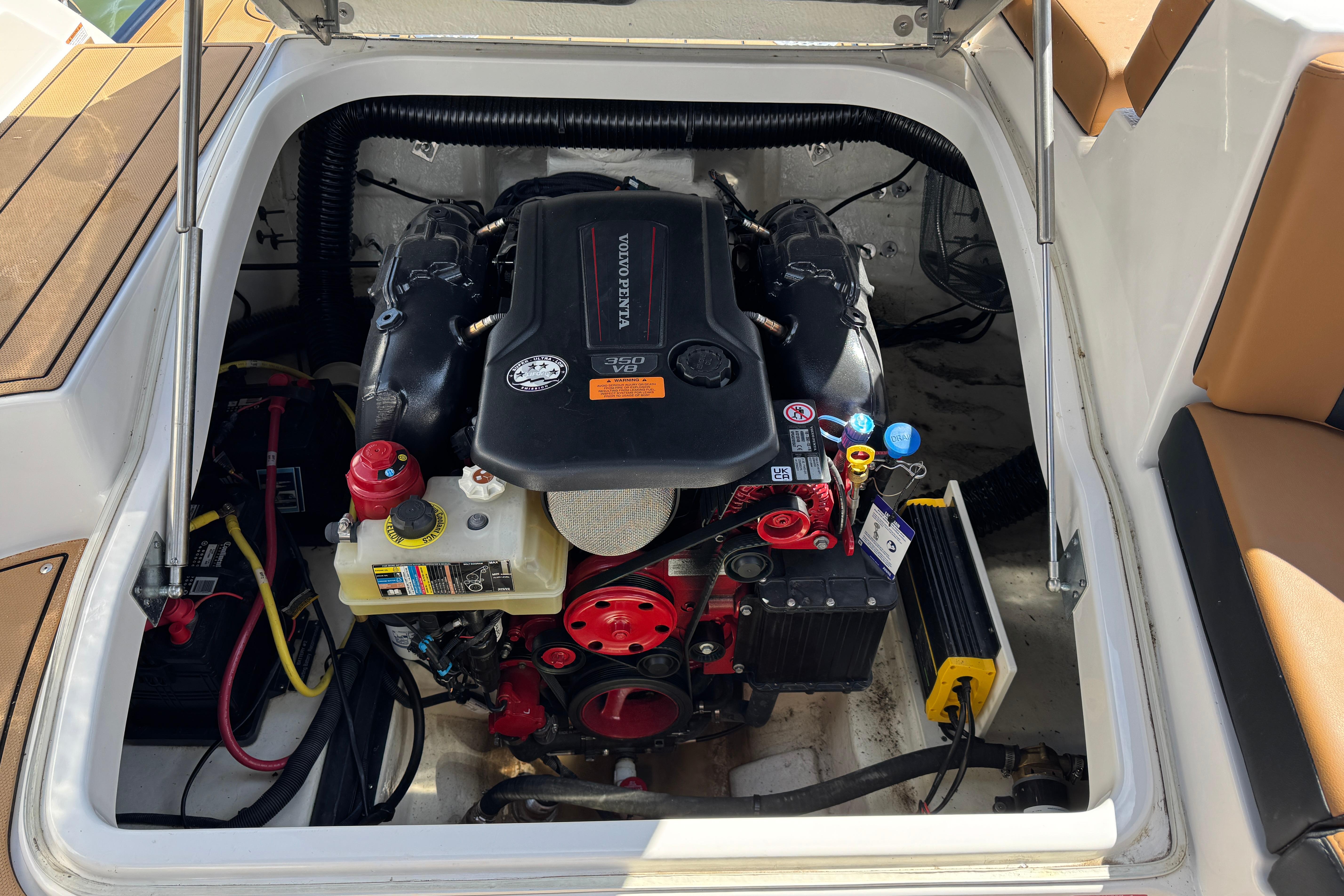 Engine compartment of 2023 Chaparral 26 Surf boat with Volvo Penta engine.