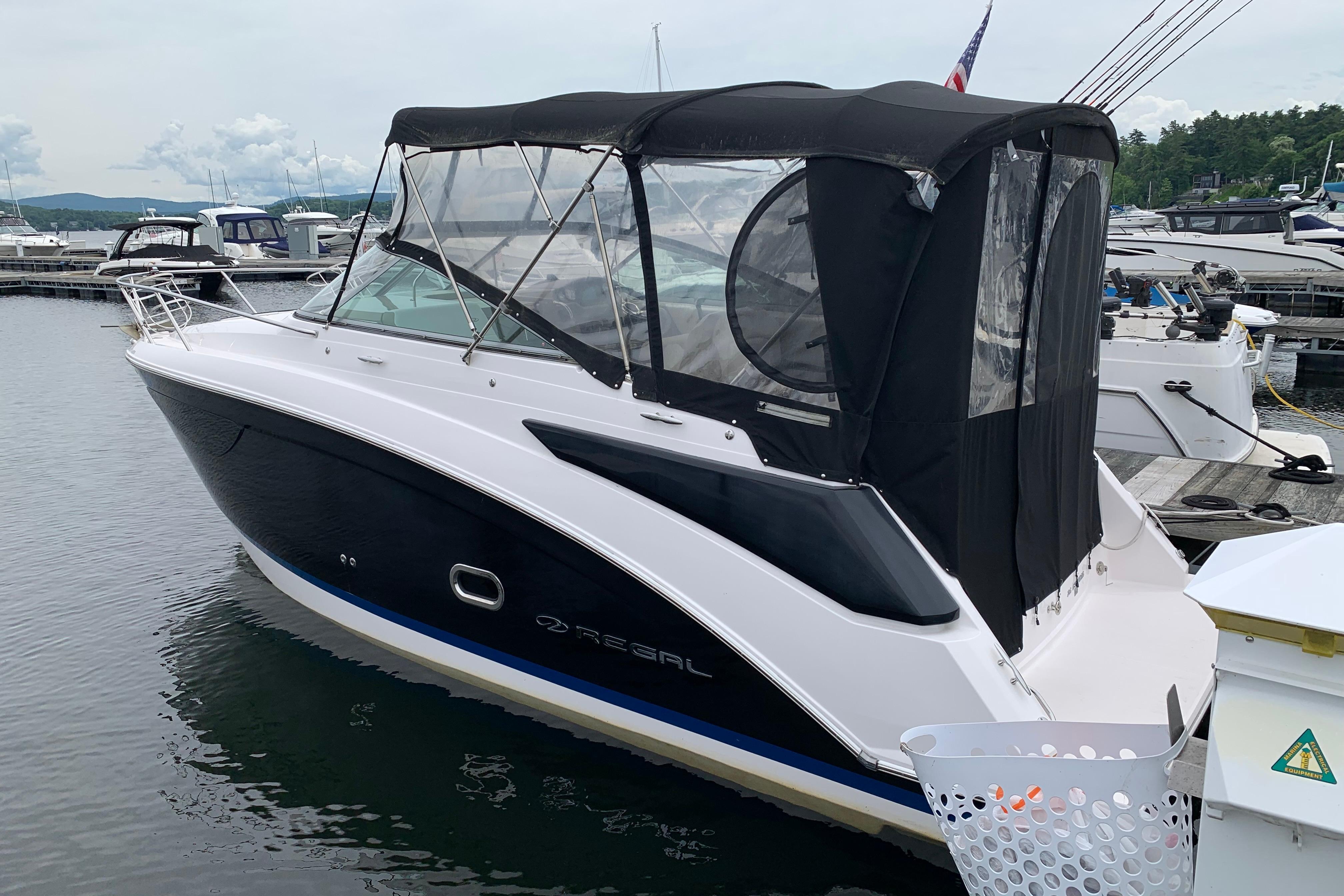 2017 Regal 26 Express boat docked at marina with black canopy.