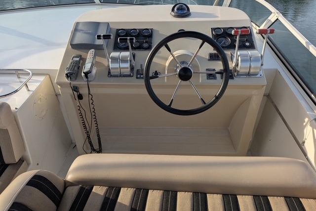 Helm of 2004 Navigator 57 yacht with steering wheel and control panel.