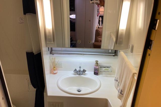 Bathroom interior of 1994 Cruisers Yachts 3675 Esprit with sink and mirror.