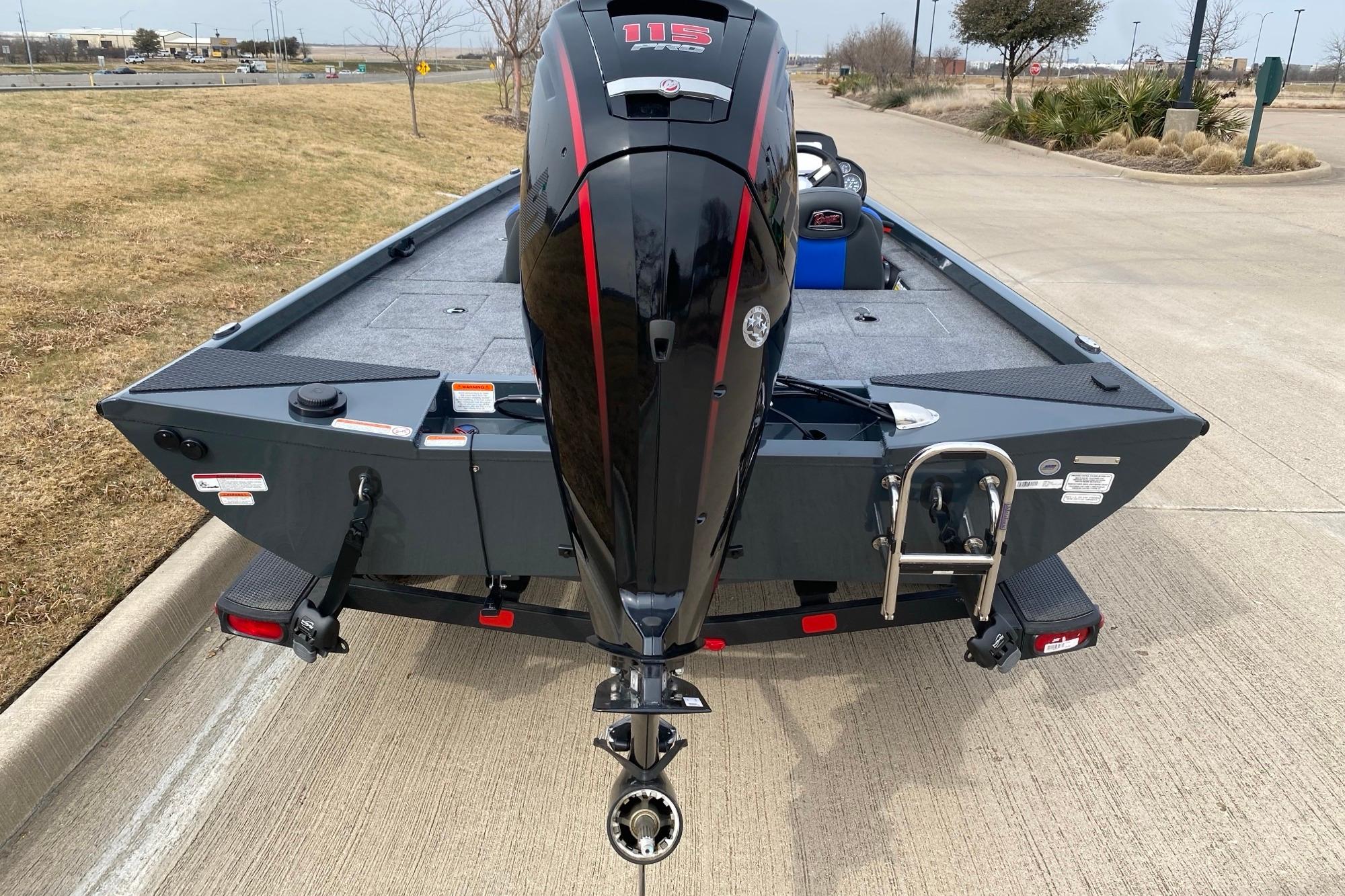 2026 Ranger RT188C boat with powerful outboard motor, parked on a concrete surface.
