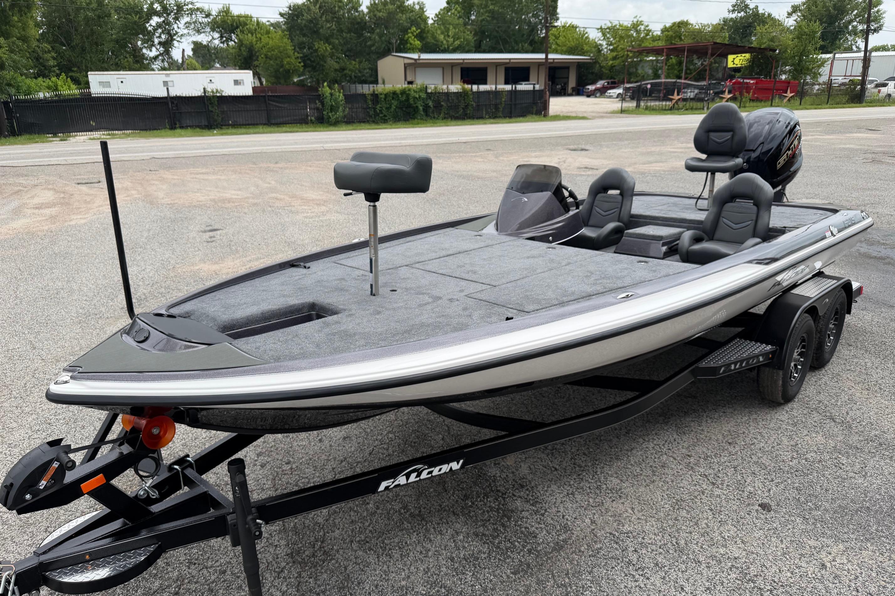 2027 Falcon Boats F215 on trailer, sleek design, dual seats, outboard motor.
