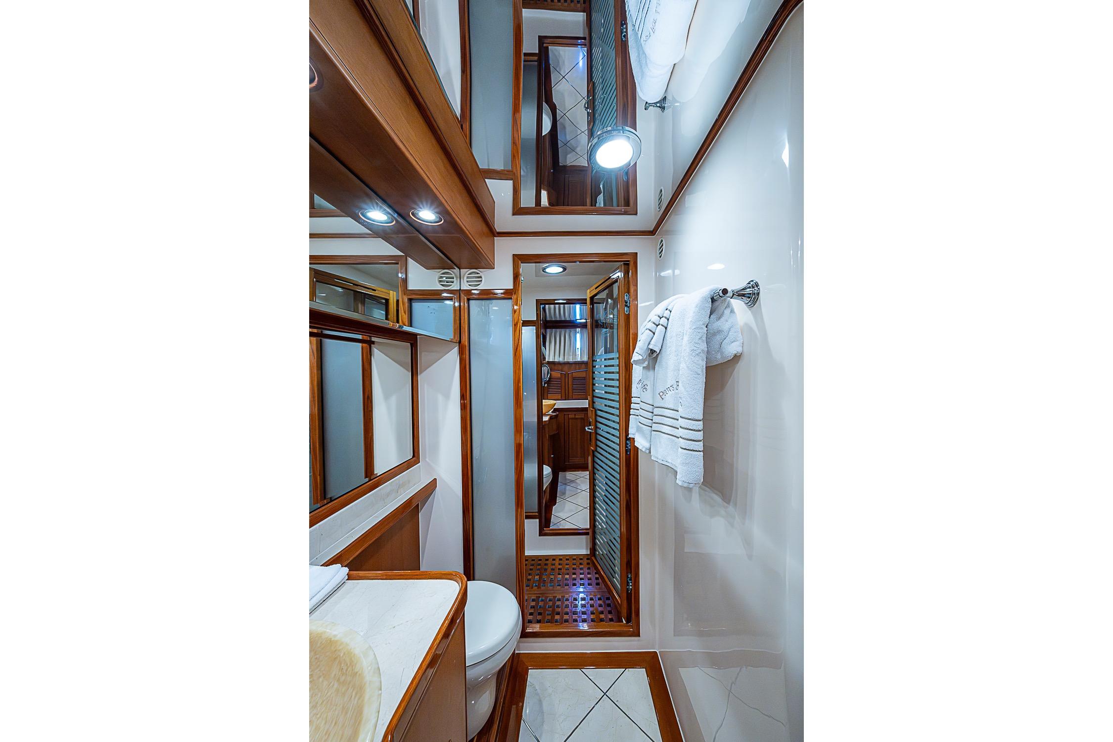 Luxurious bathroom interior of 2014 Marlow 80 Explorer yacht with wood accents and modern fixtures.