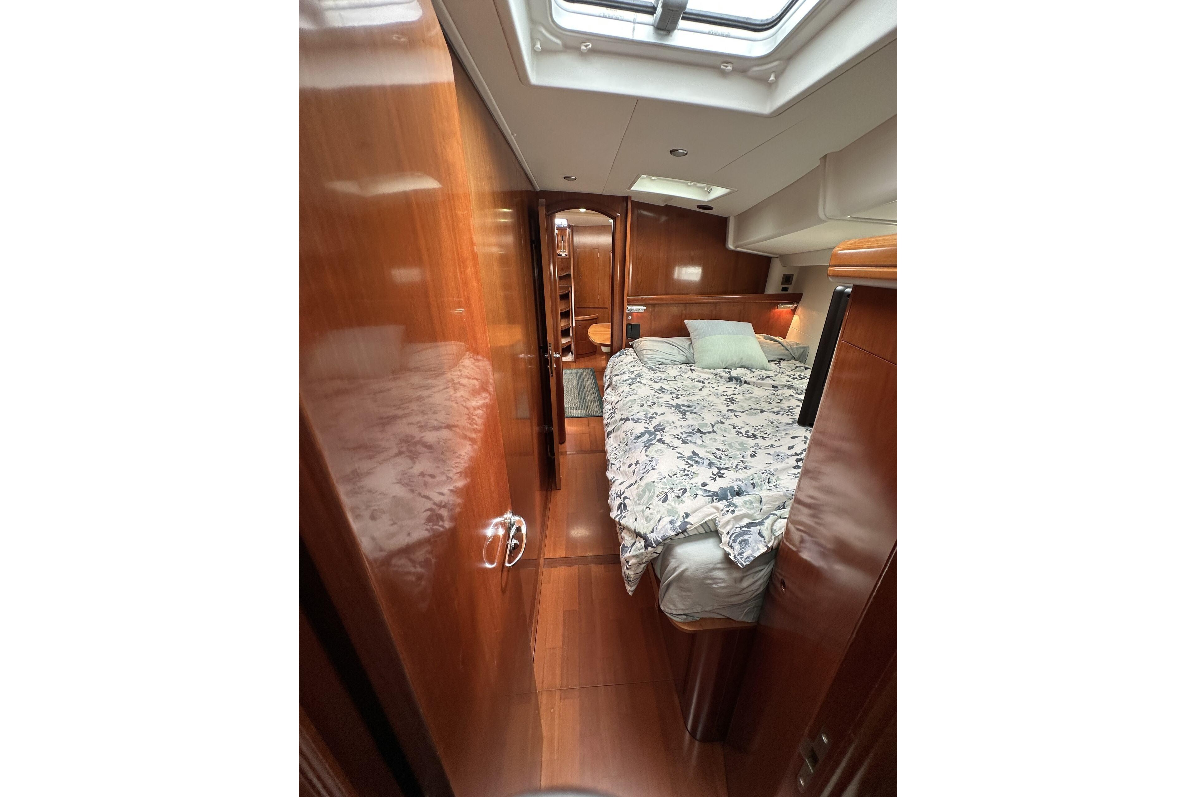 Luxurious cabin interior of a 2003 Beneteau 57 yacht with elegant wood finish.