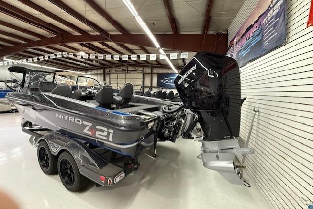 2024 Nitro ZV21 boat with Mercury engine in showroom setting.