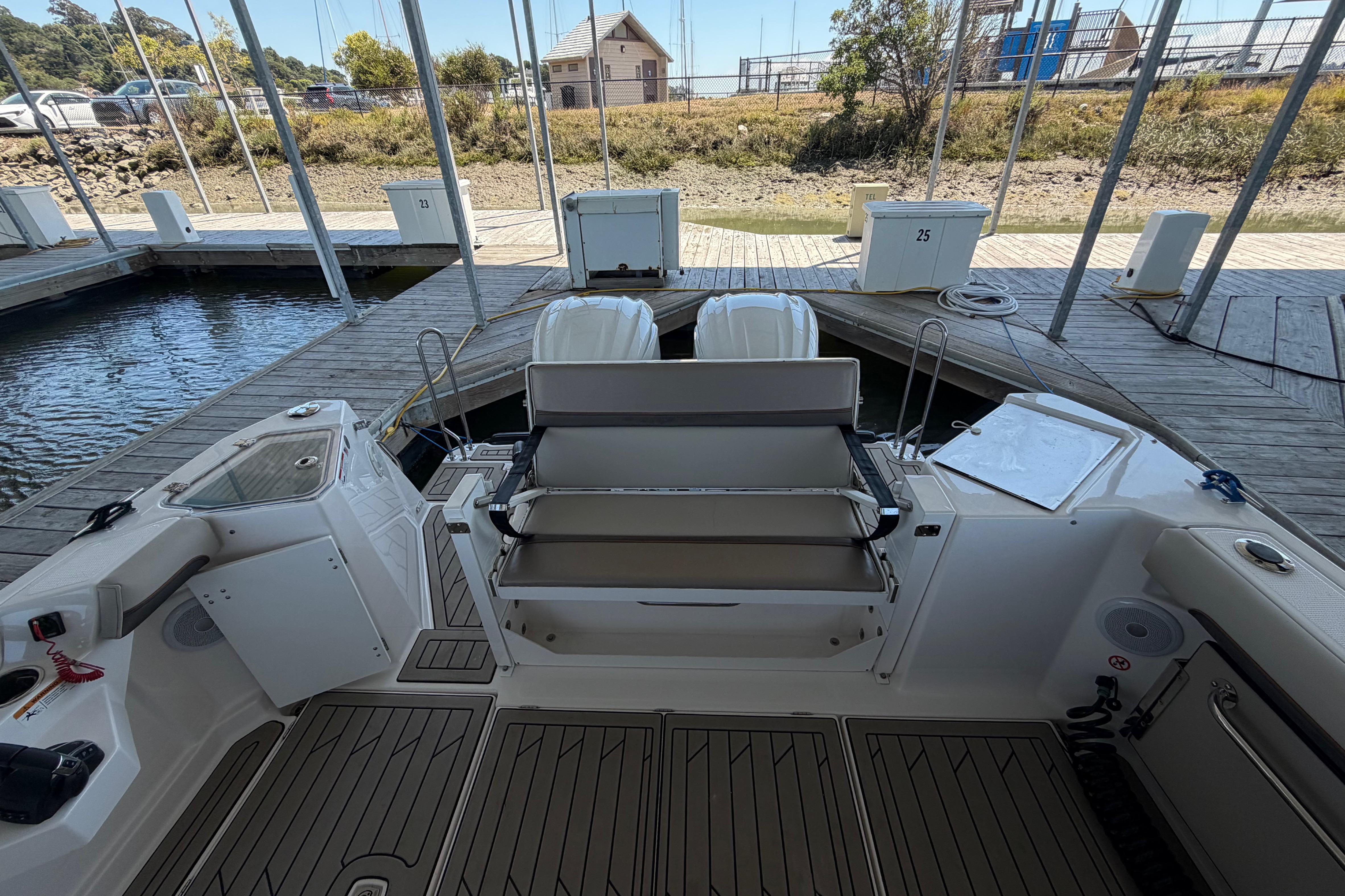 2023 Cutwater C-288 Coupe boat docked, featuring spacious deck and seating area.