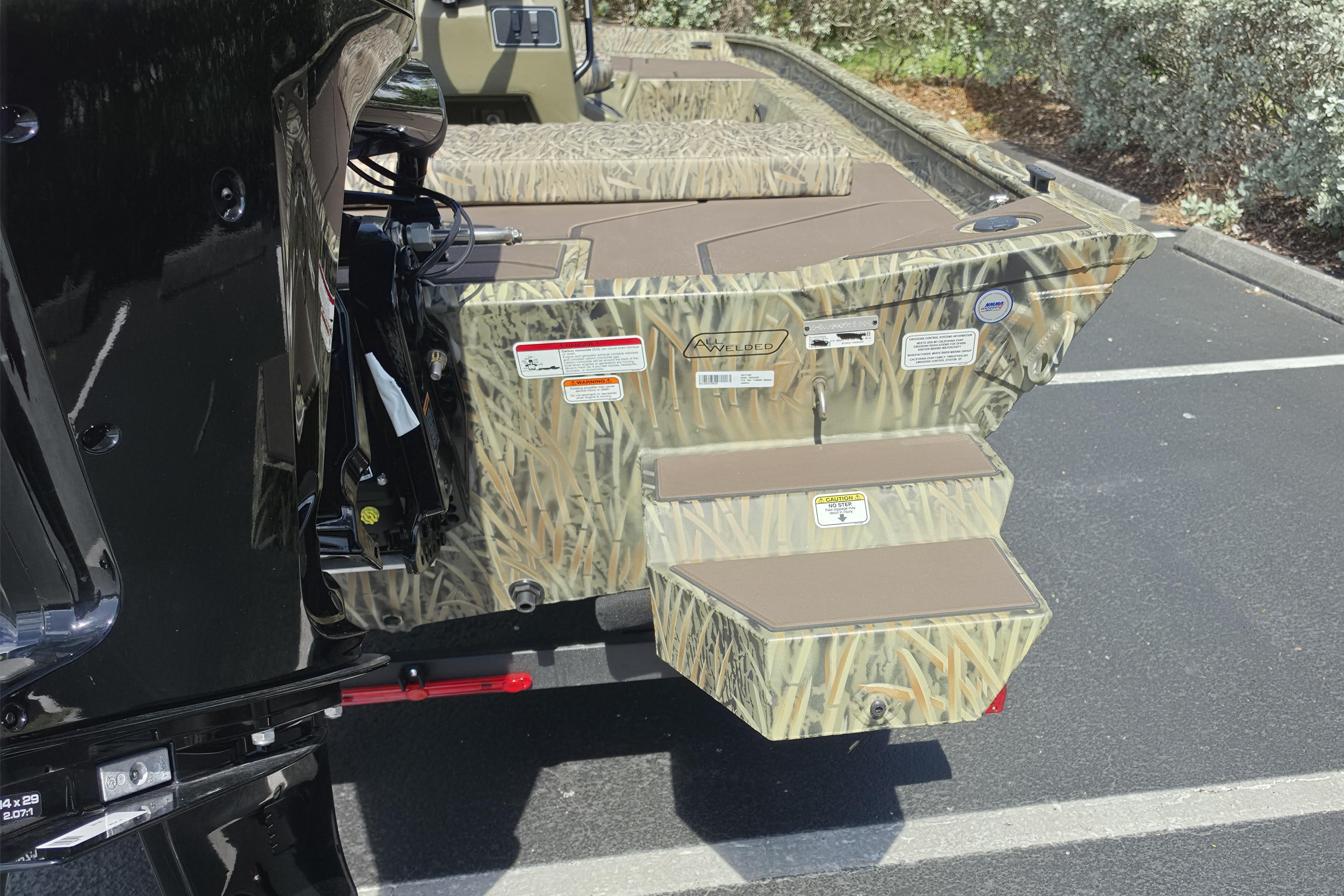 2026 Tracker Grizzly 1860 CC boat with camouflage design in parking lot.