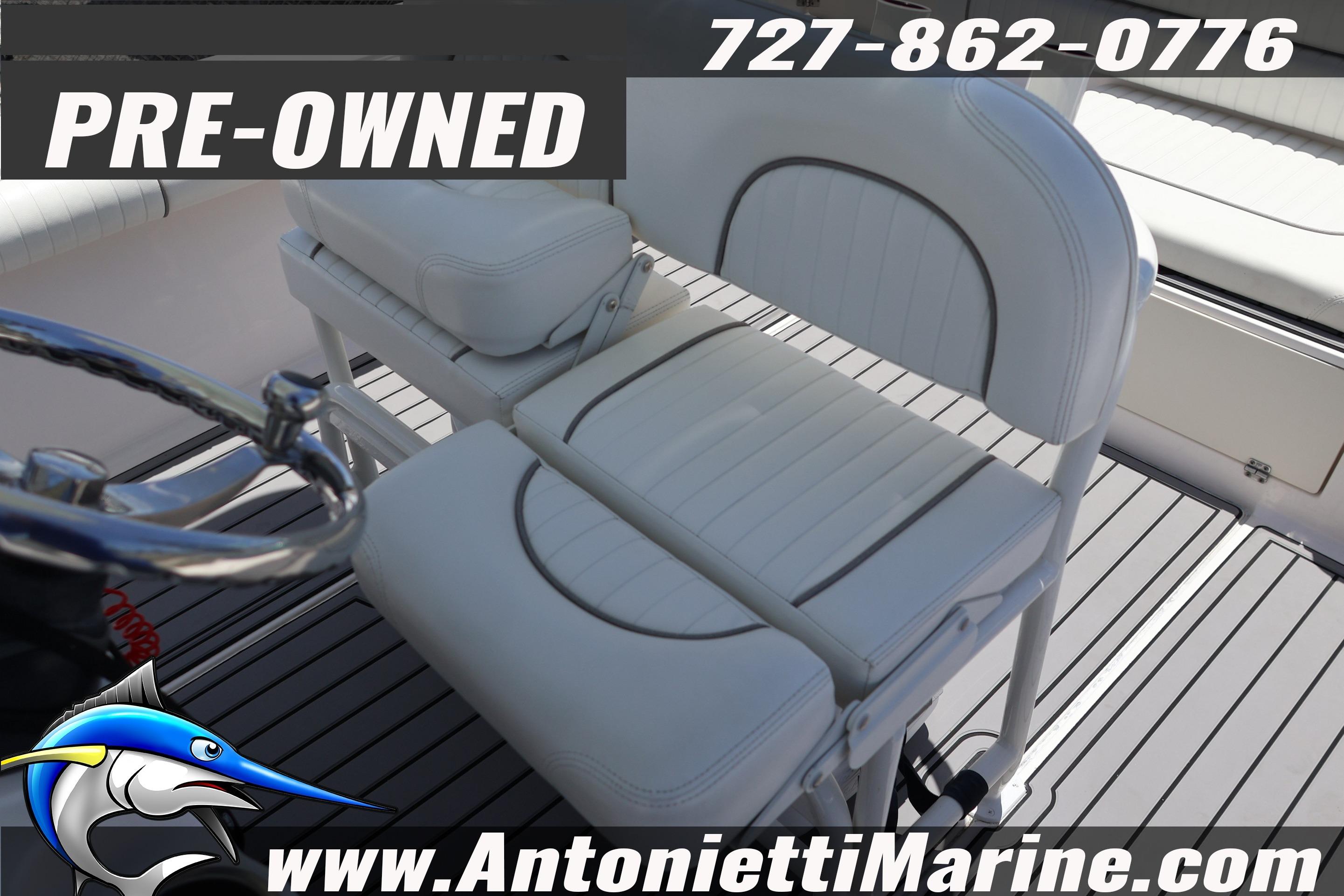 Pre-owned 2019 Sea Born LX24 Center Console boat interior with seating and steering wheel.