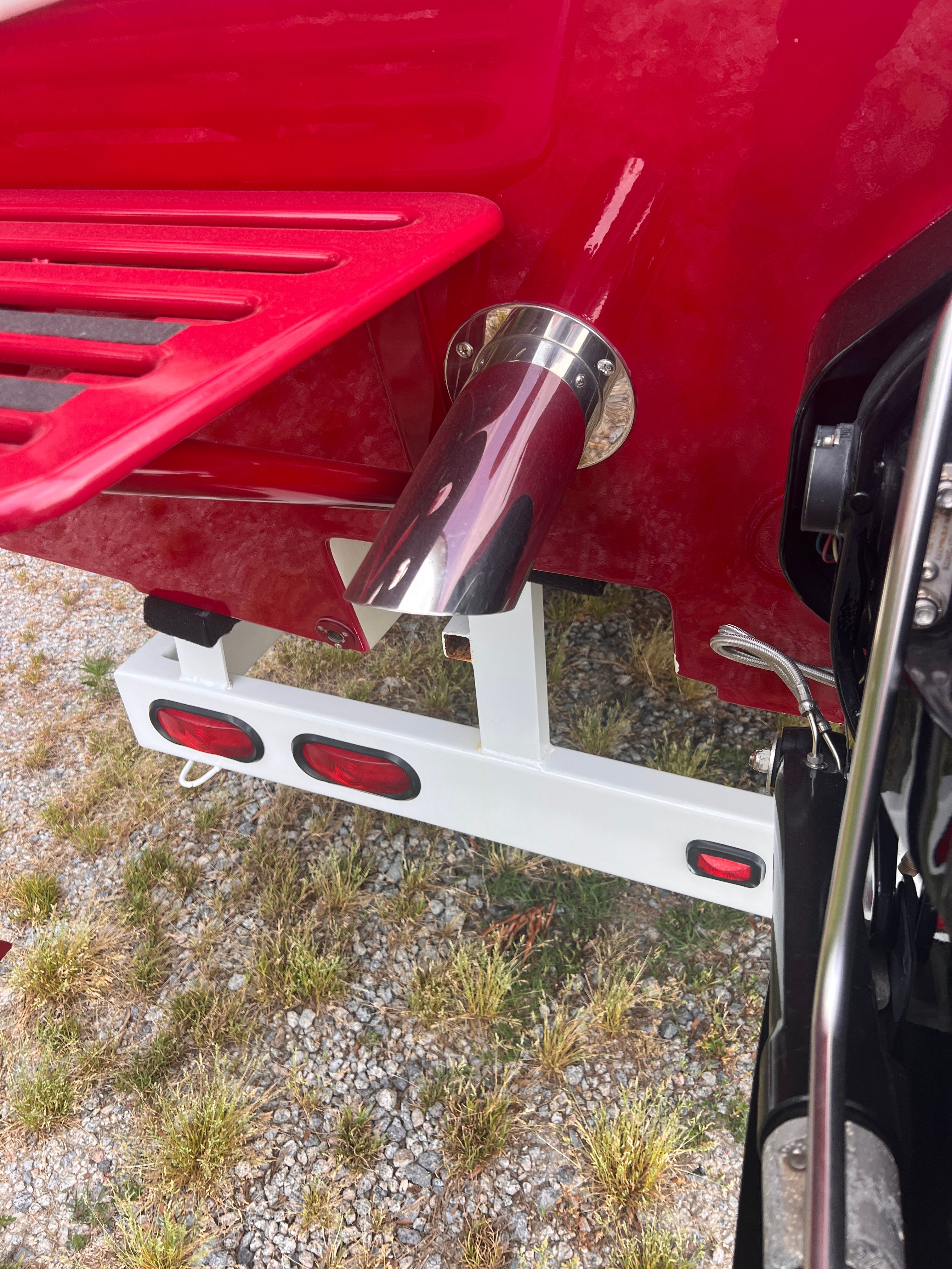 Close-up of a 2008 red Cheetah Fastcat's exhaust on a trailer.
