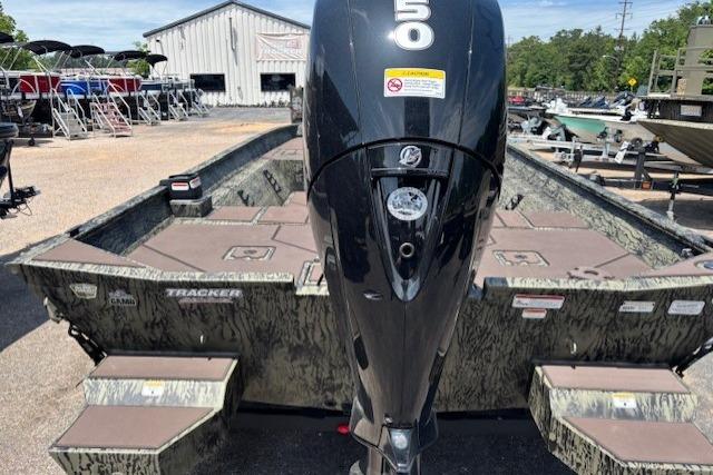 2026 Tracker Grizzly 2072 CC boat with powerful outboard motor in a marina setting.