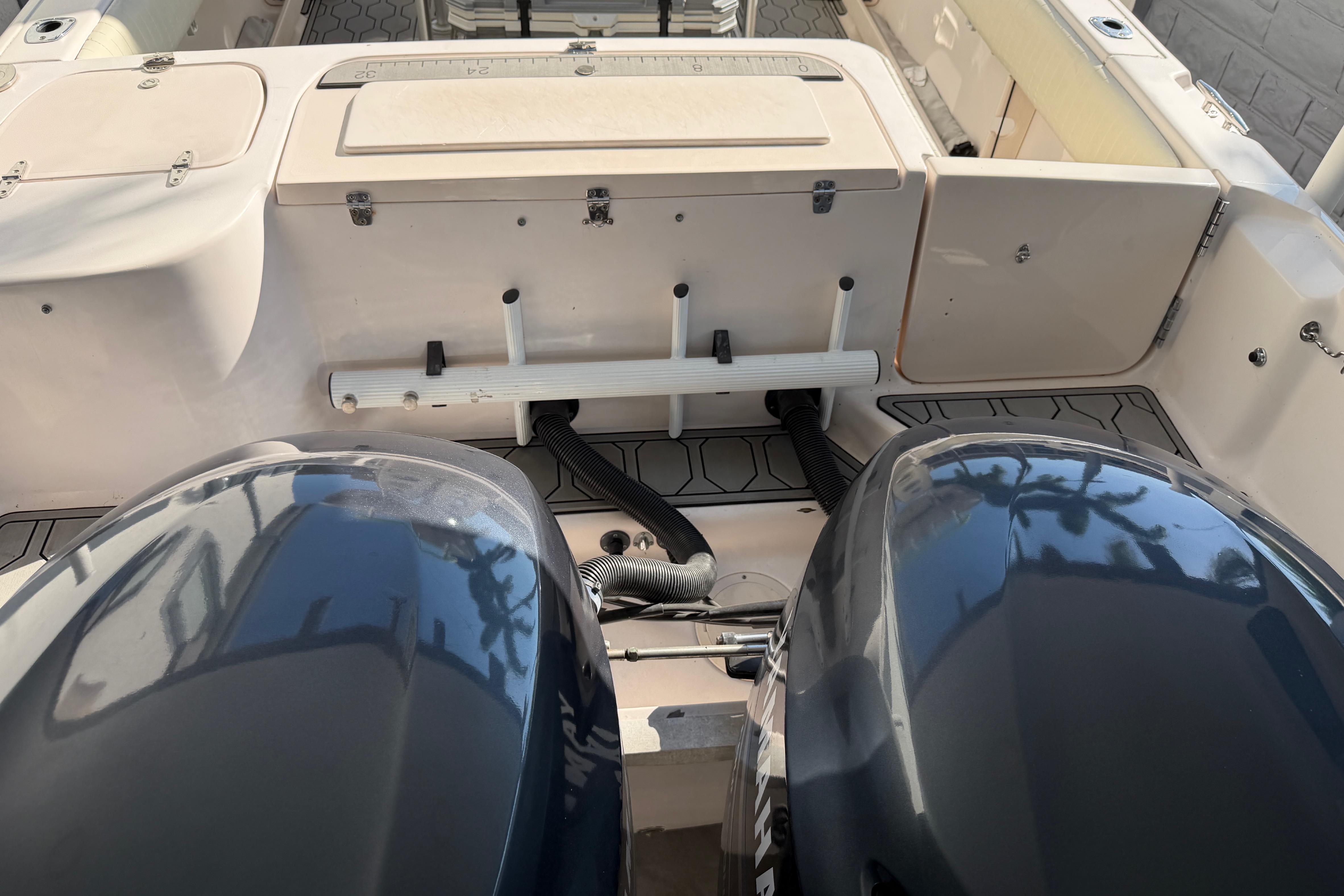 2004 Grady White 273 boat with dual engines and storage compartments.