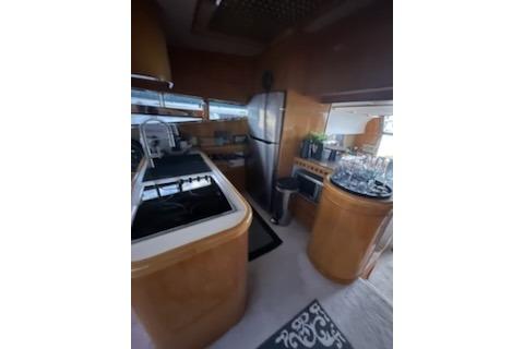 1994 Johnson High-Tech 65 Euro yacht kitchen with modern appliances and wooden cabinetry.