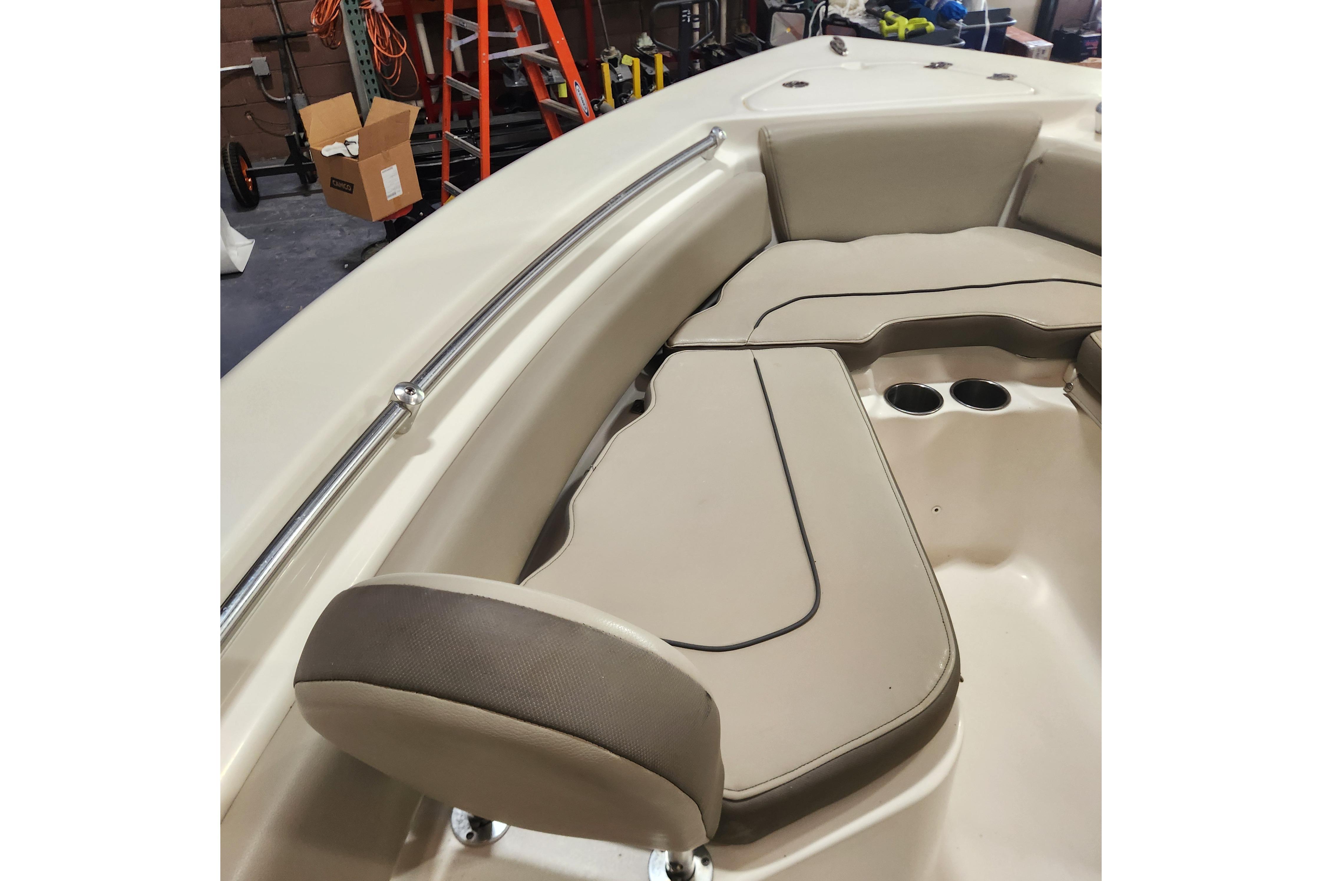 2023 Key West 219 FS boat interior with cushioned seating and cup holders.