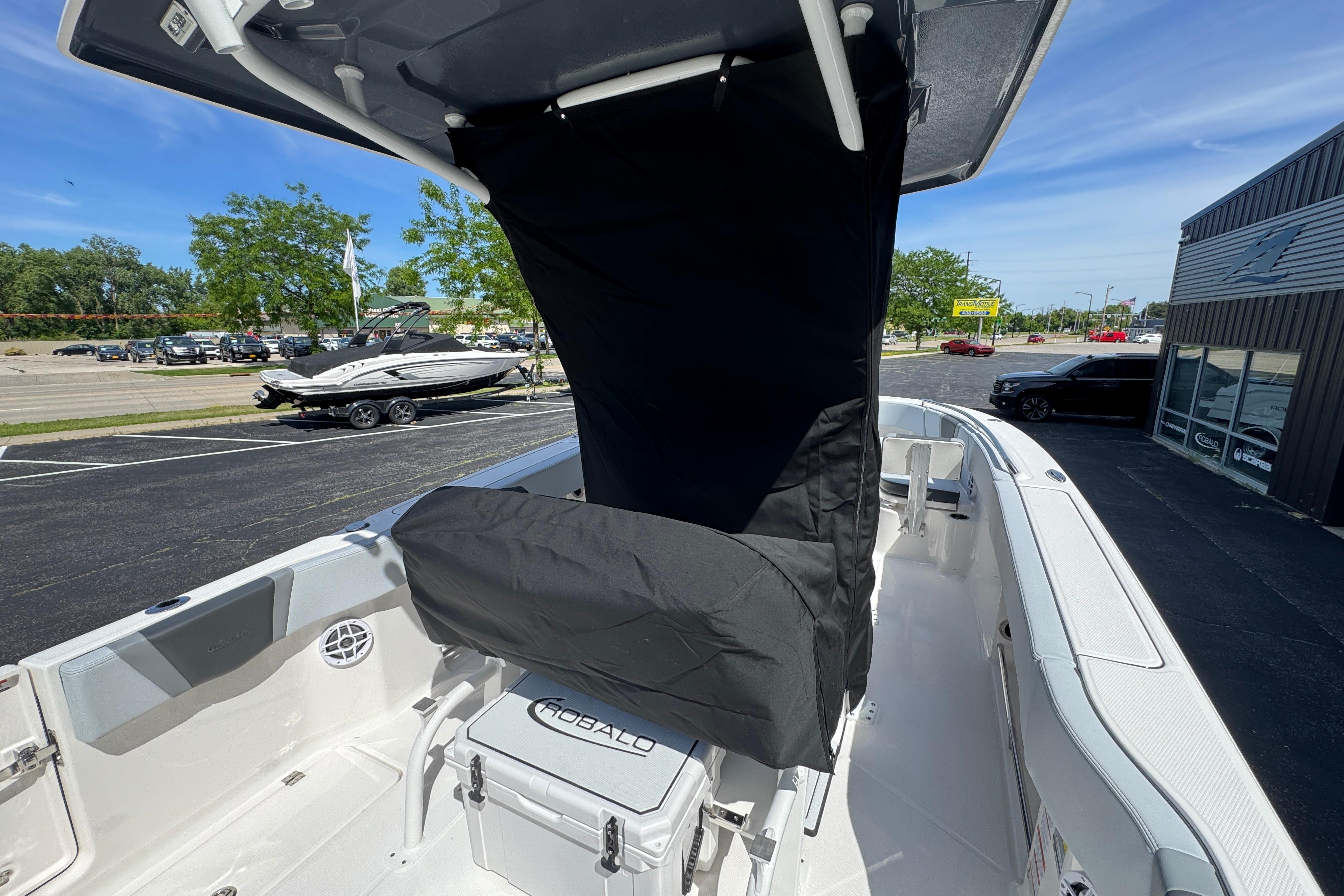 2026 Robalo R250 Center Console boat with covered seating, parked outdoors.