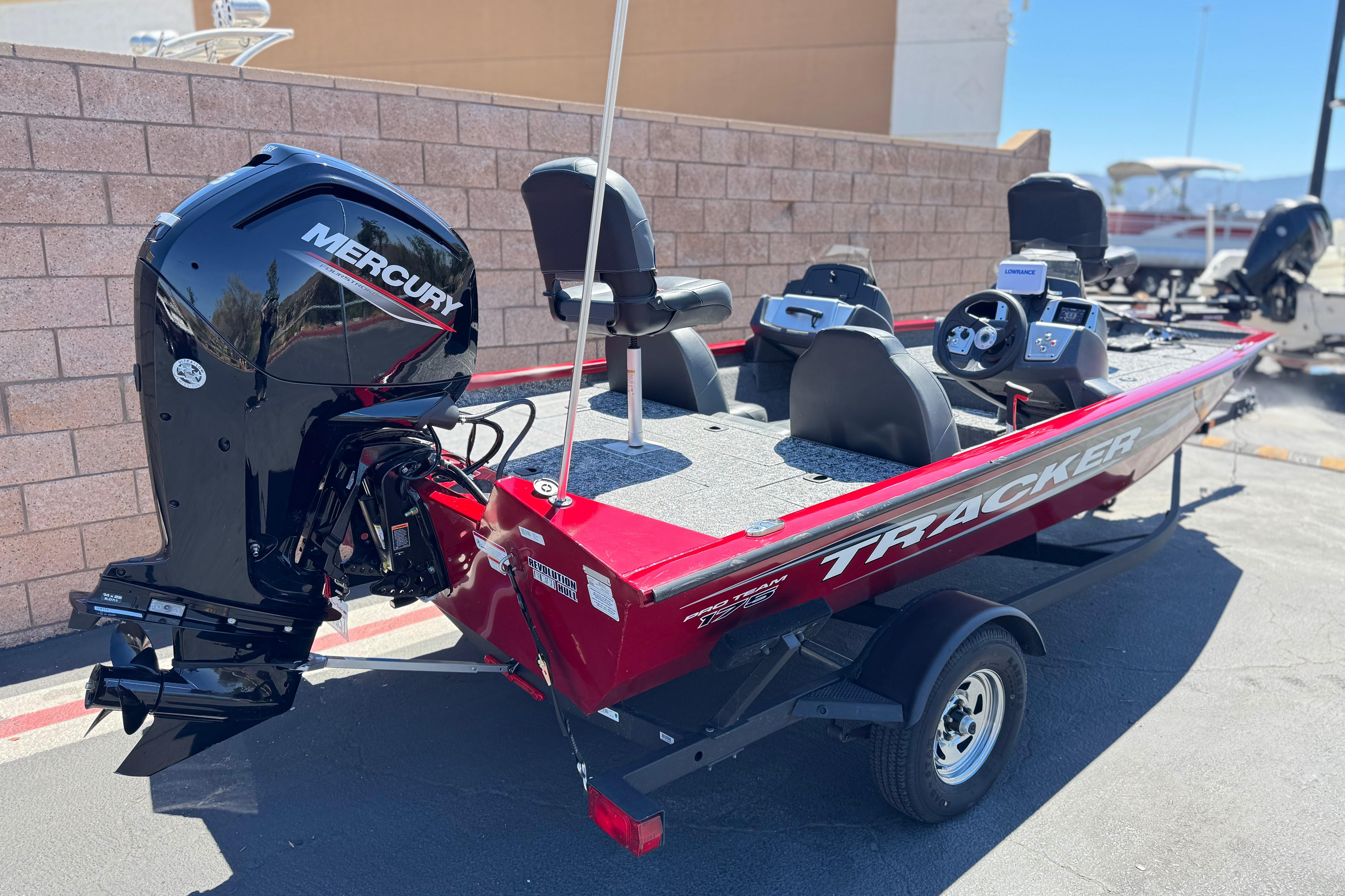 2025 Tracker Pro Team 175 TXW boat with Mercury engine, parked outdoors.