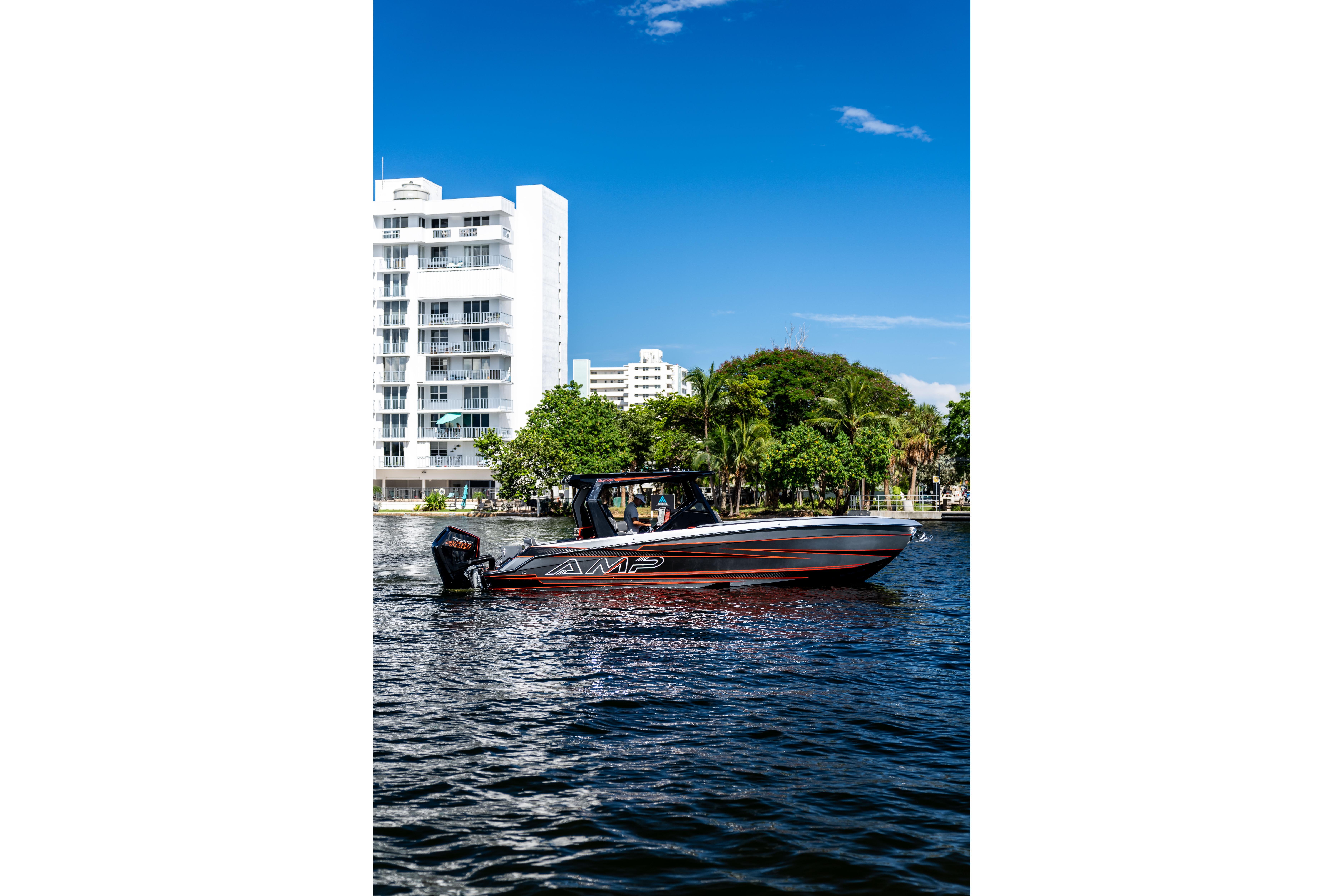 AMP 333 boat cruising on water near modern buildings, 2026 model.