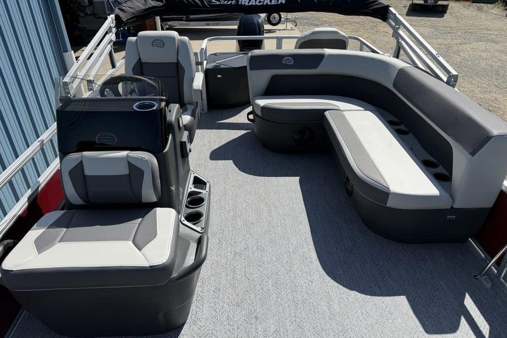 2026 Sun Tracker Bass Buggy 18 DLX pontoon boat interior with gray seating and steering console.