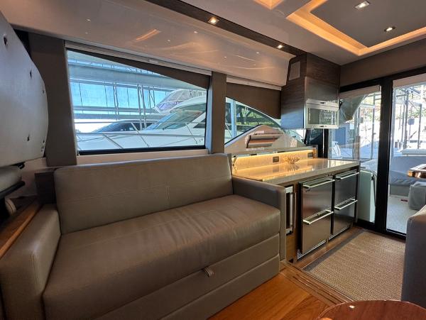 Interior of 2019 Tiara Yachts C53 with modern furnishings and large windows.