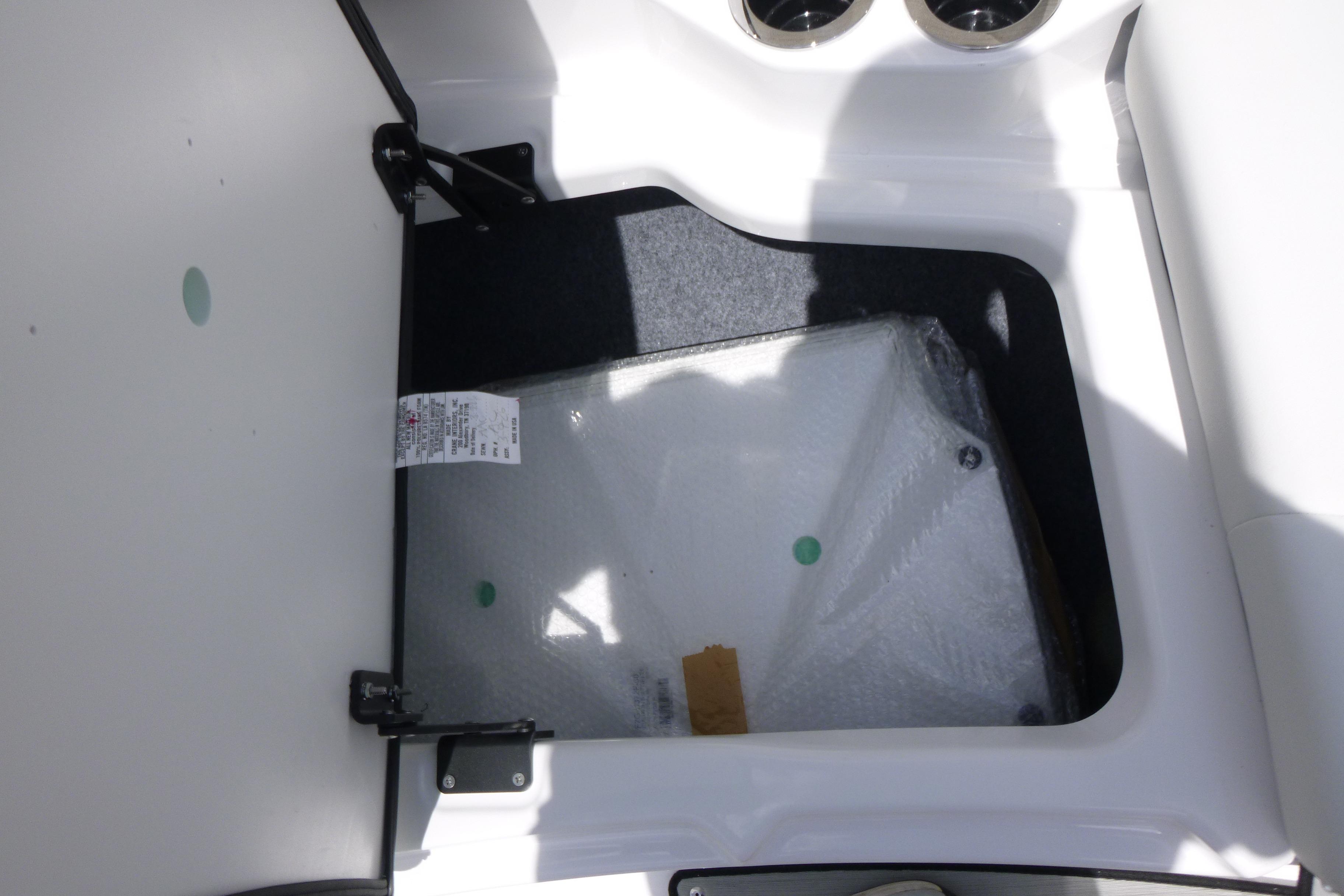 Storage compartment in 2026 Yamaha Boats 222S, featuring a hinged lid and interior space.