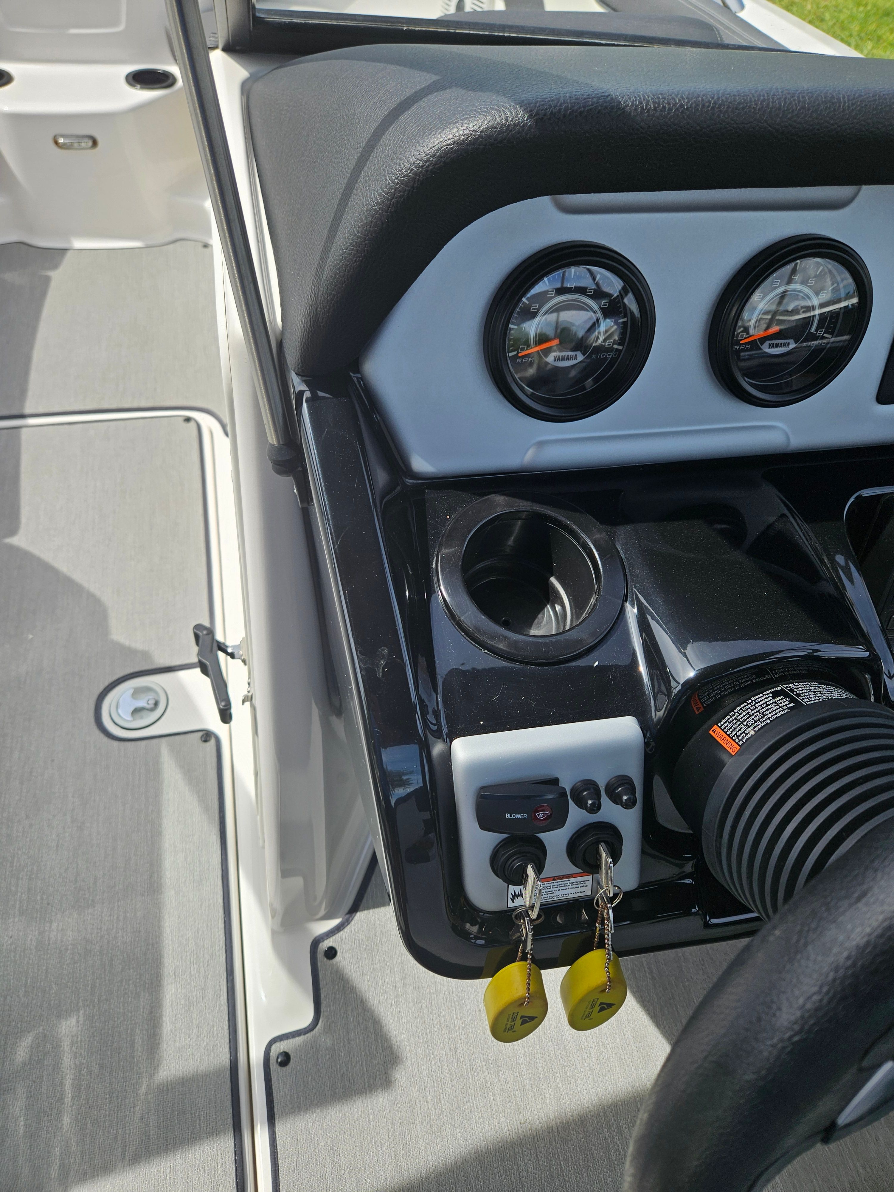 Dashboard of a 2022 Yamaha SX210 boat with keys and gauges.