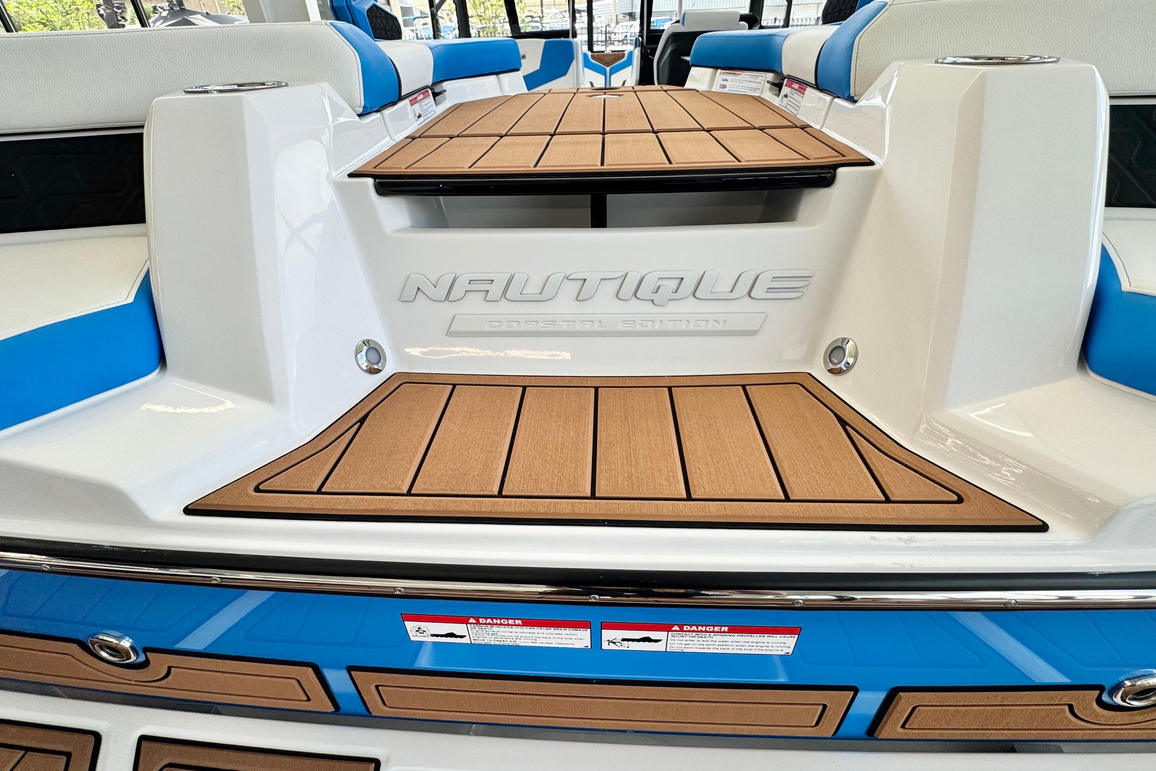 2026 Nautique Super Air Nautique GS22 boat interior with teak flooring and blue accents.