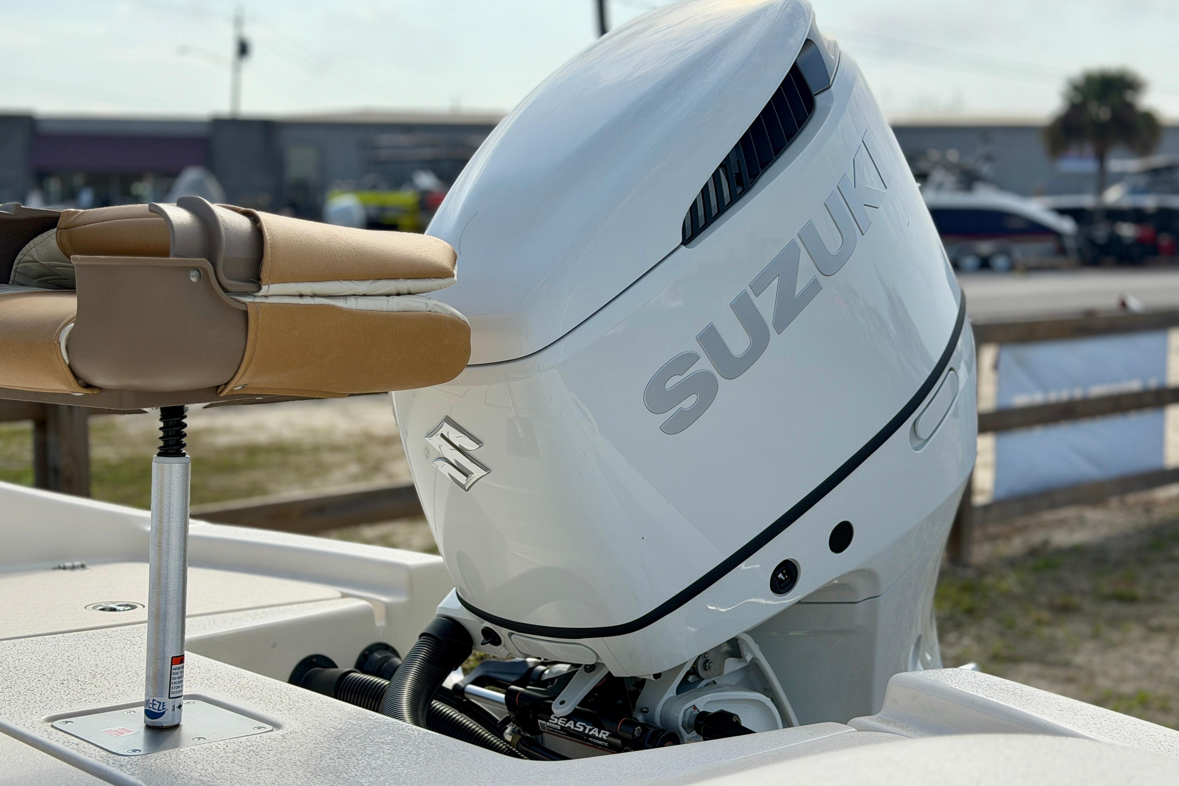 2026 Carolina Skiff 24 Ultra Elite with Suzuki outboard motor, docked outdoors.