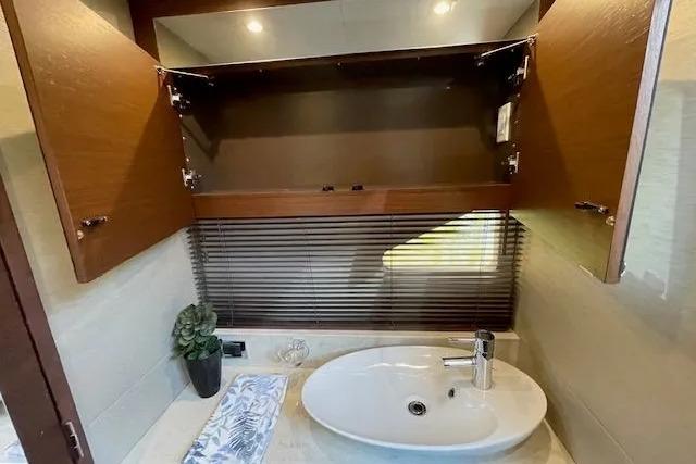 Luxurious bathroom interior of 2016 Sea Ray Sundancer 510 yacht with modern sink and cabinetry.