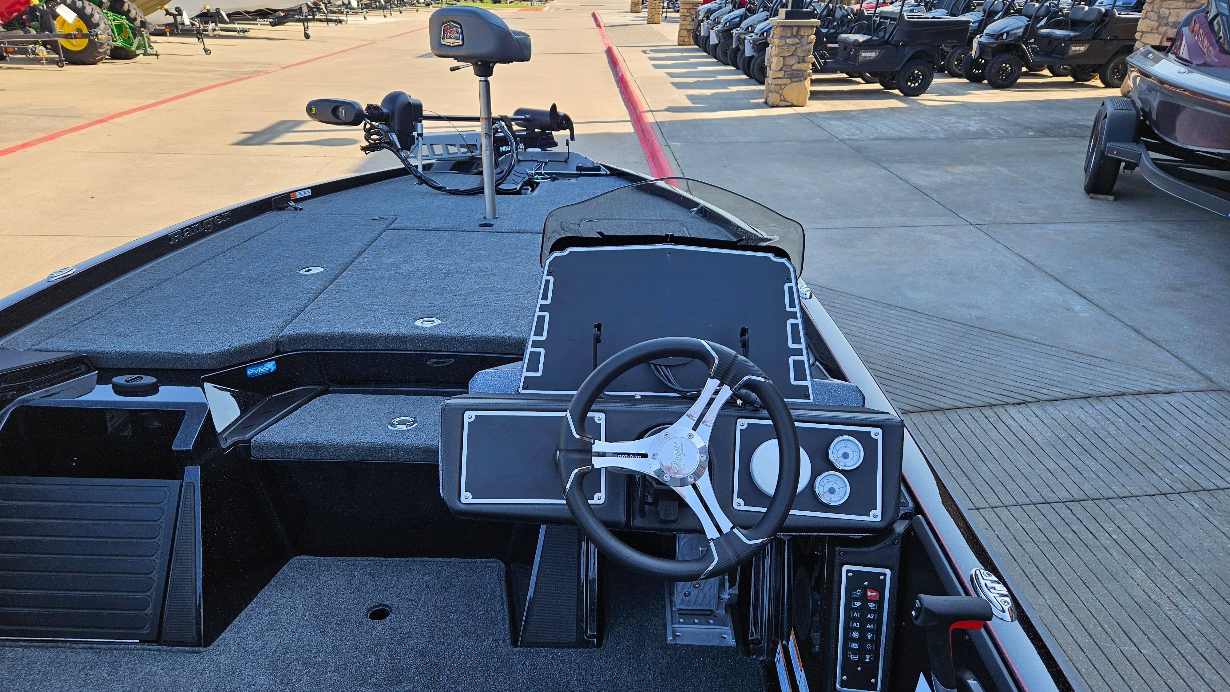 2025 Ranger Z520 boat interior with steering wheel and control panel, parked in a dealership.