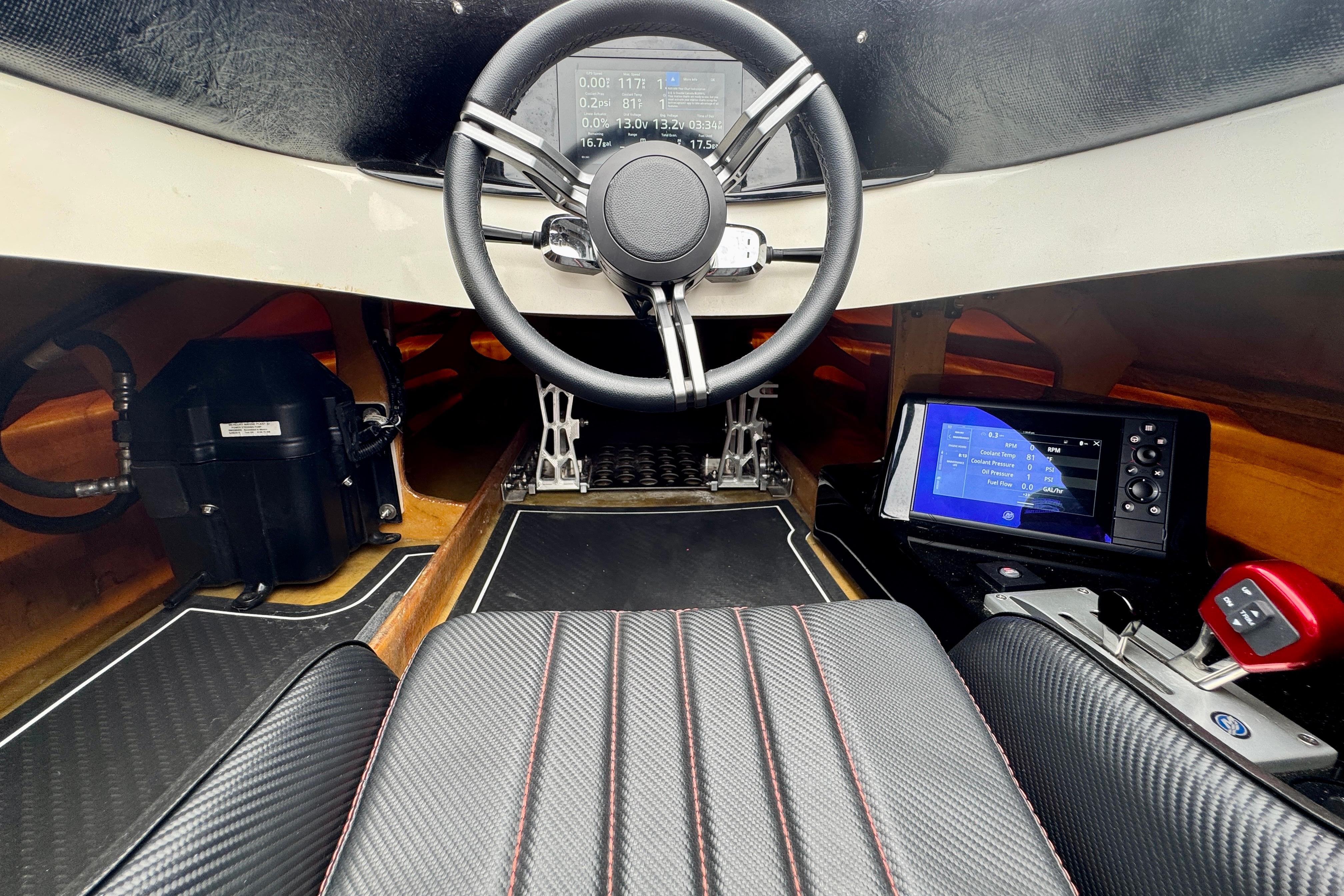 Interior of a 2016 Argo 23 boat with steering wheel and digital displays.