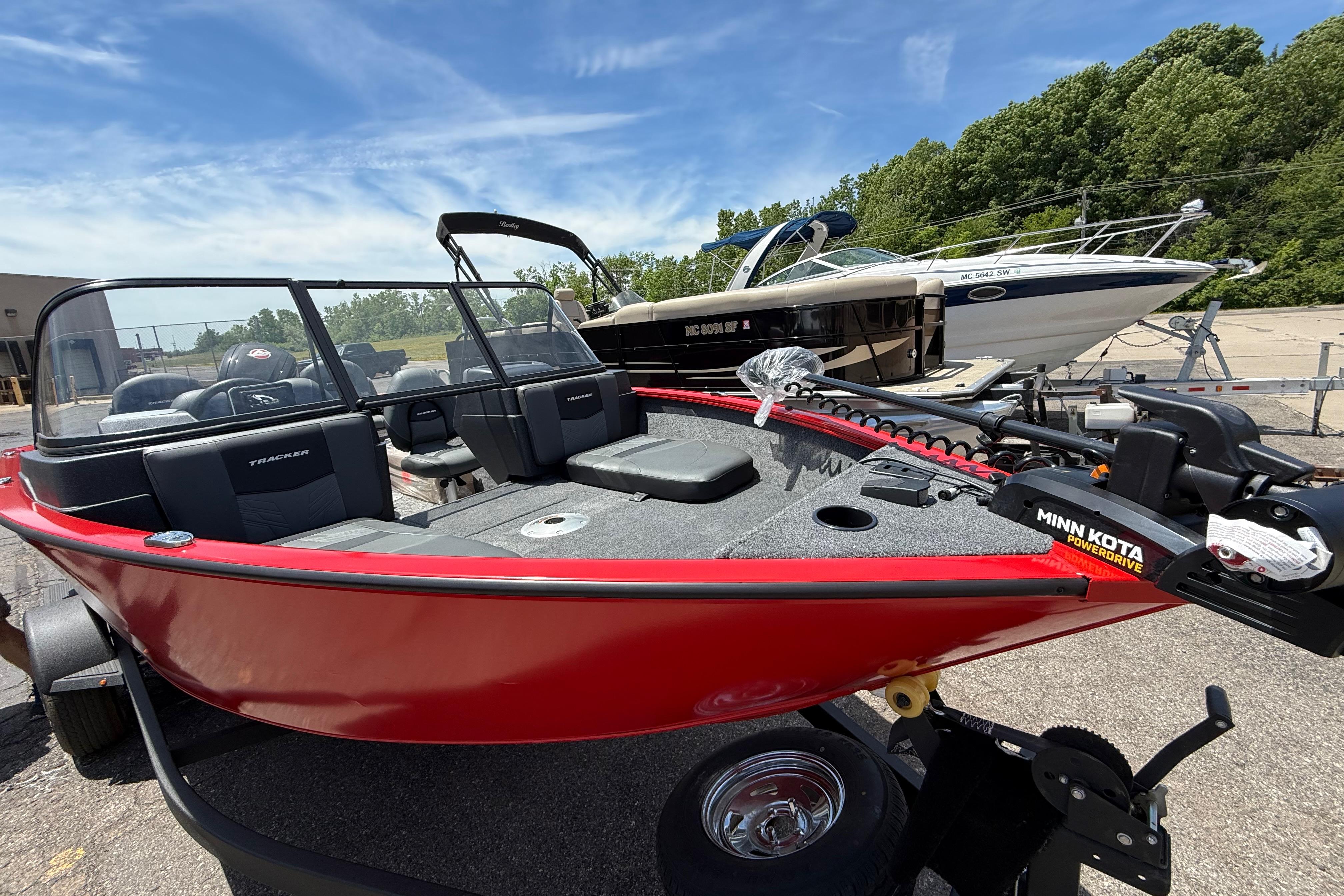 2026 Tracker Pro Guide V-175 Combo boat, red exterior, parked outdoors with Minn Kota PowerDrive.