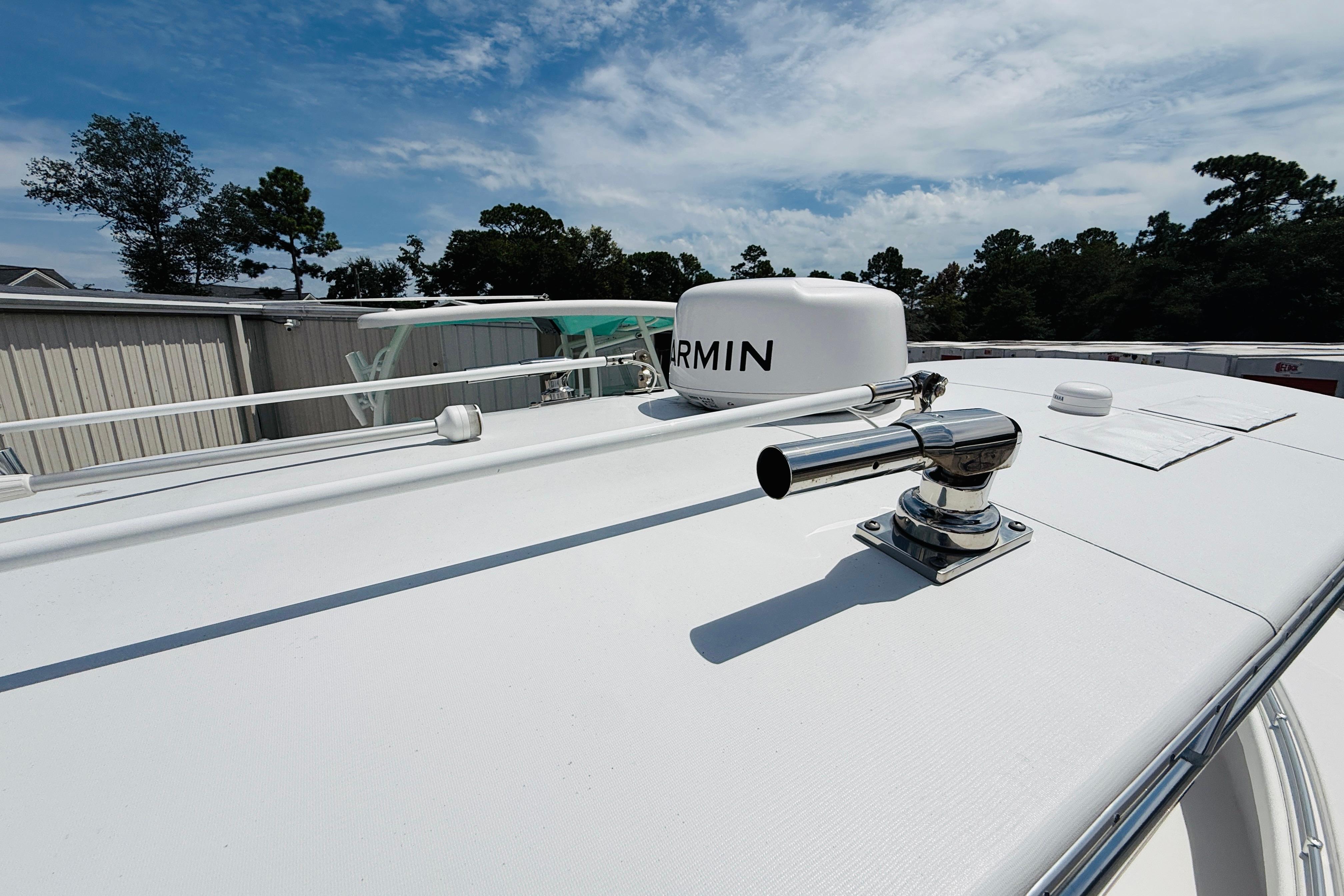 2024 Contender 25 Open boat with Garmin radar, docked under a clear sky.