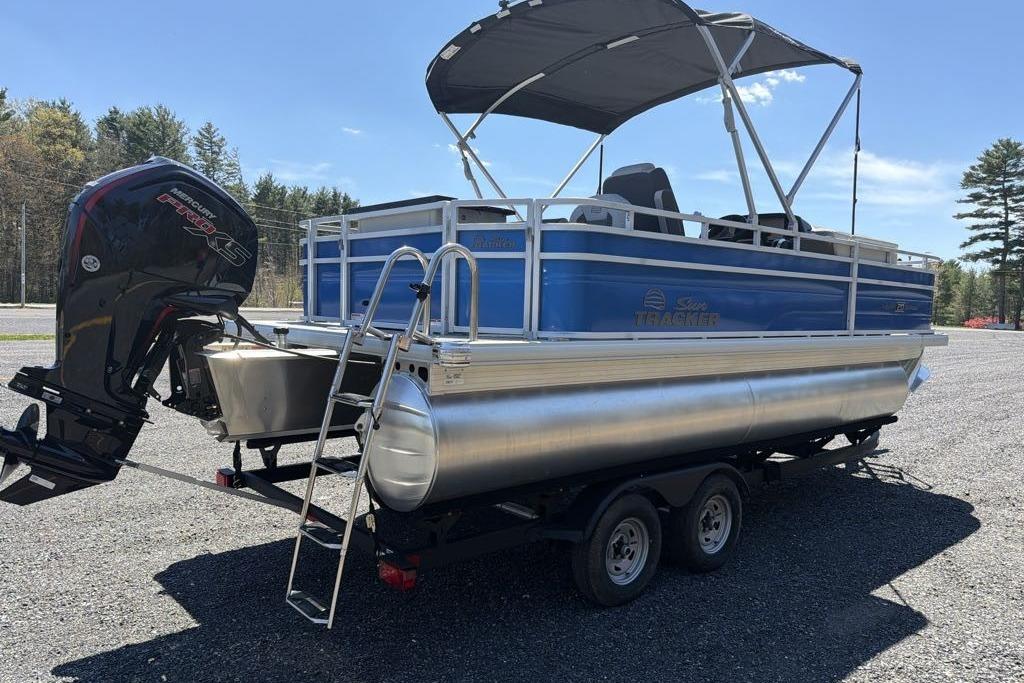 2026 Sun Tracker Fishin' Barge 20 DLX pontoon boat with Mercury engine on trailer.