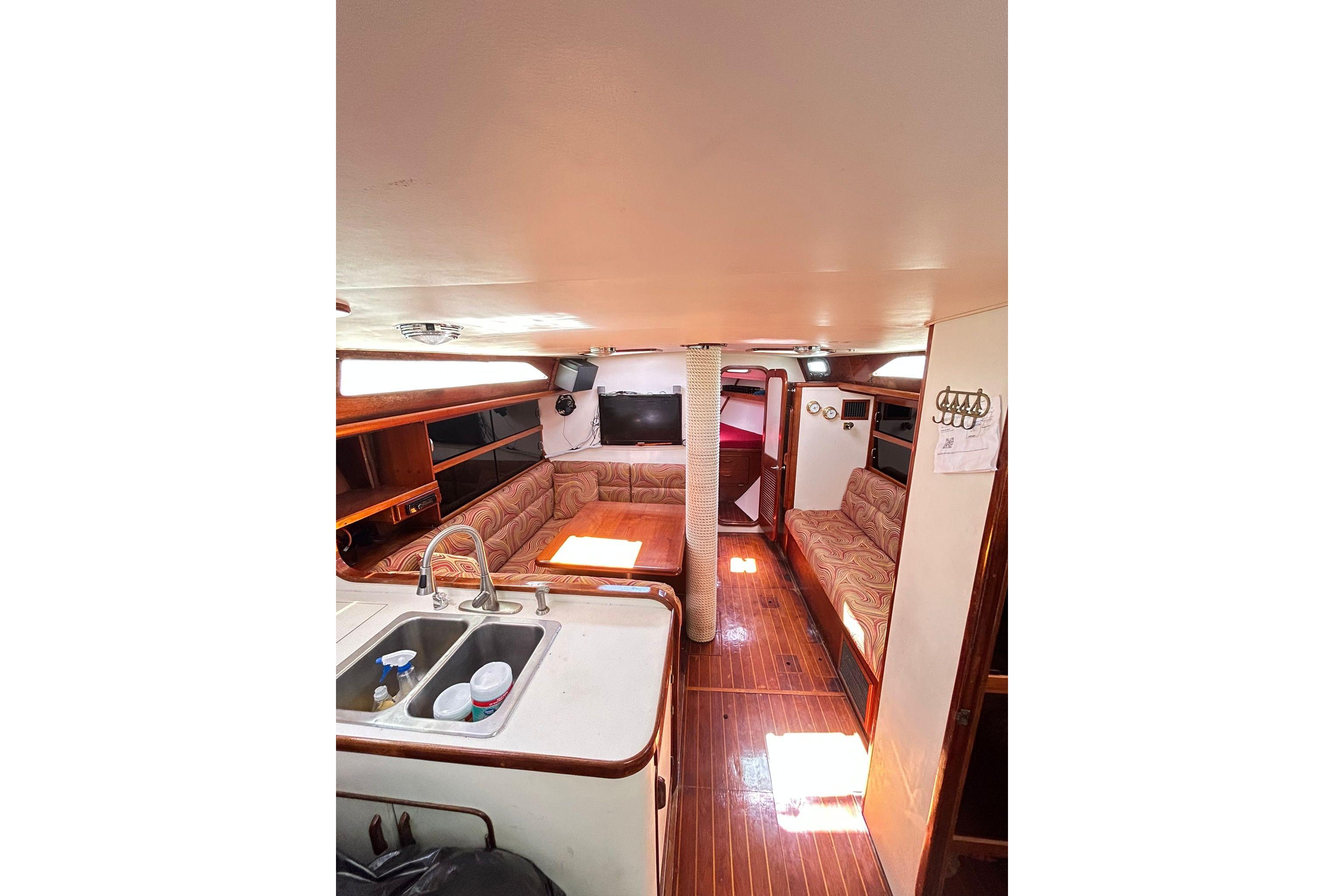 Interior of 1987 Gulfstar CSY 50 Pilot House with cozy seating and kitchen area.
