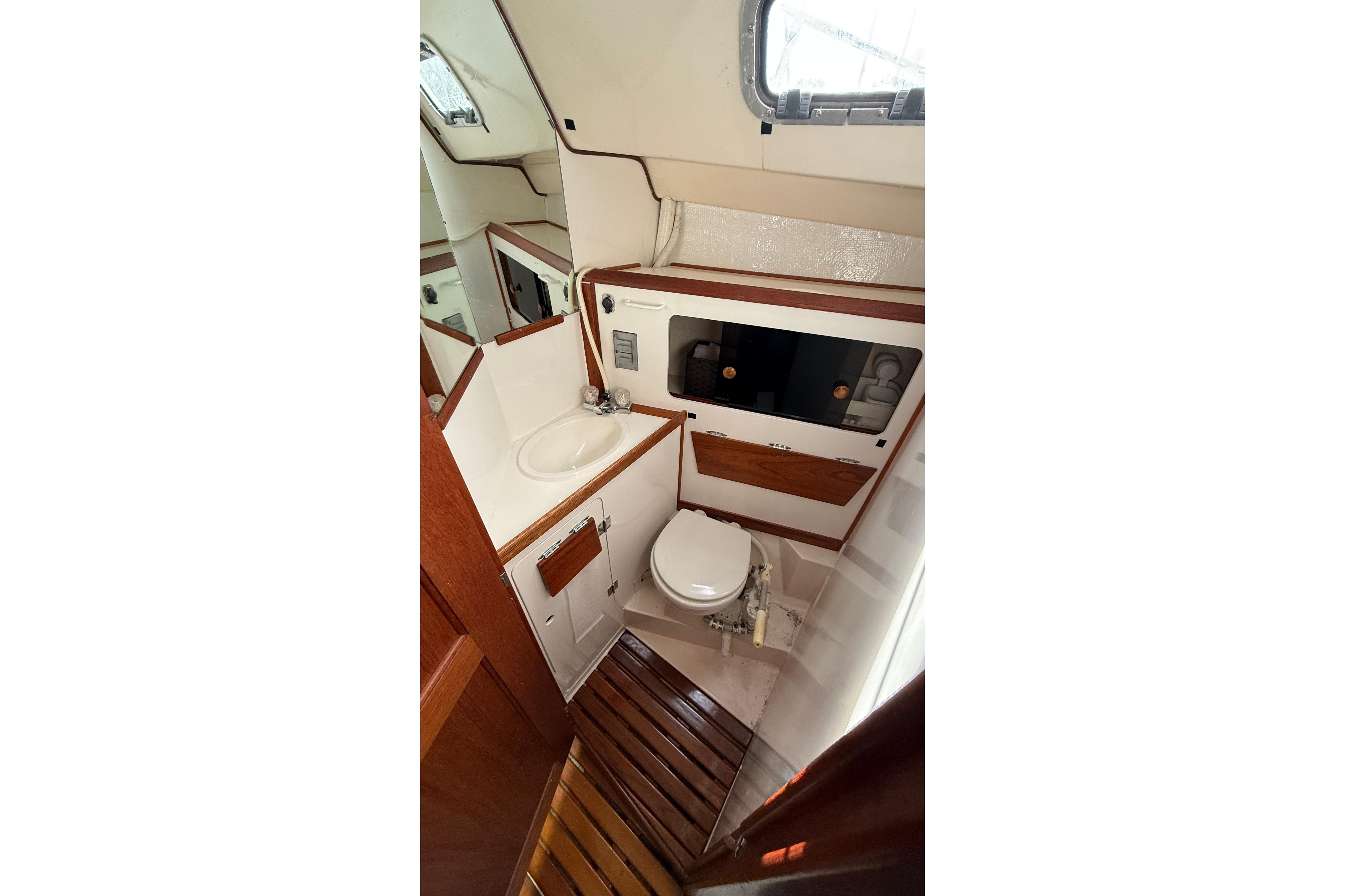 1984 Hunter 31 yacht bathroom with wooden accents and compact design.