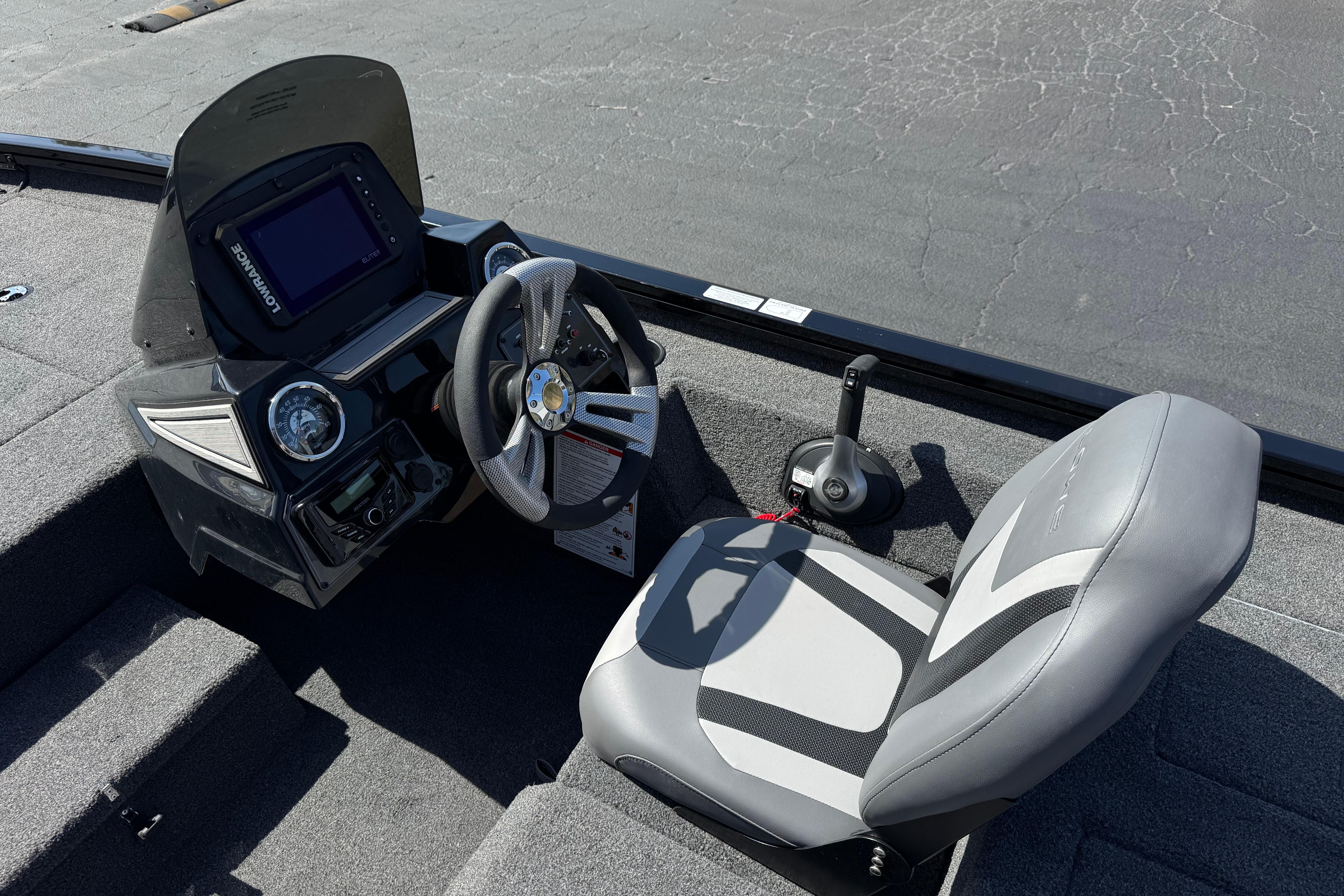 2024 Lowe Stinger 175 boat cockpit with steering wheel and control panel.
