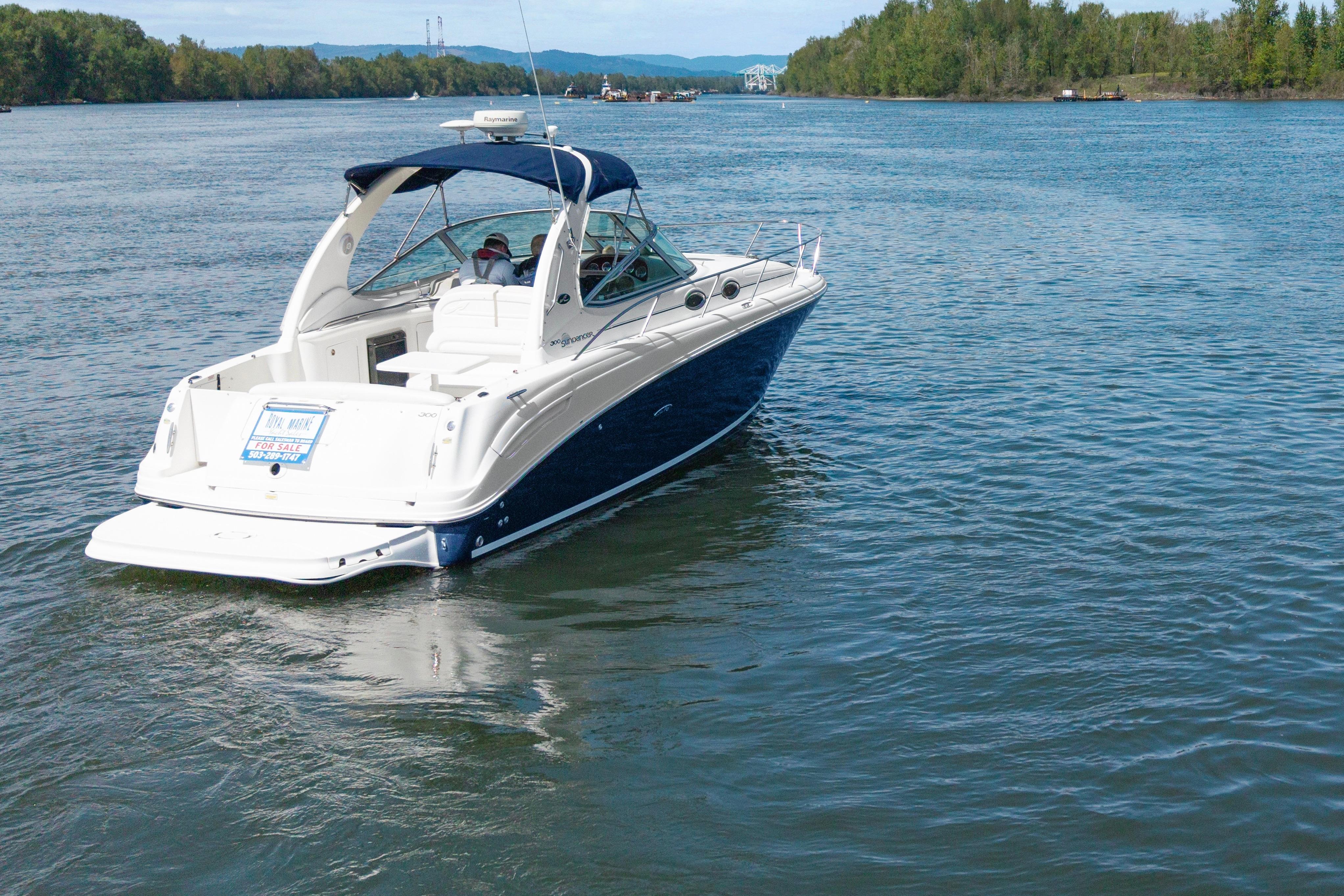 2005 Sea Ray 300 Sundancer cruising on a scenic river.