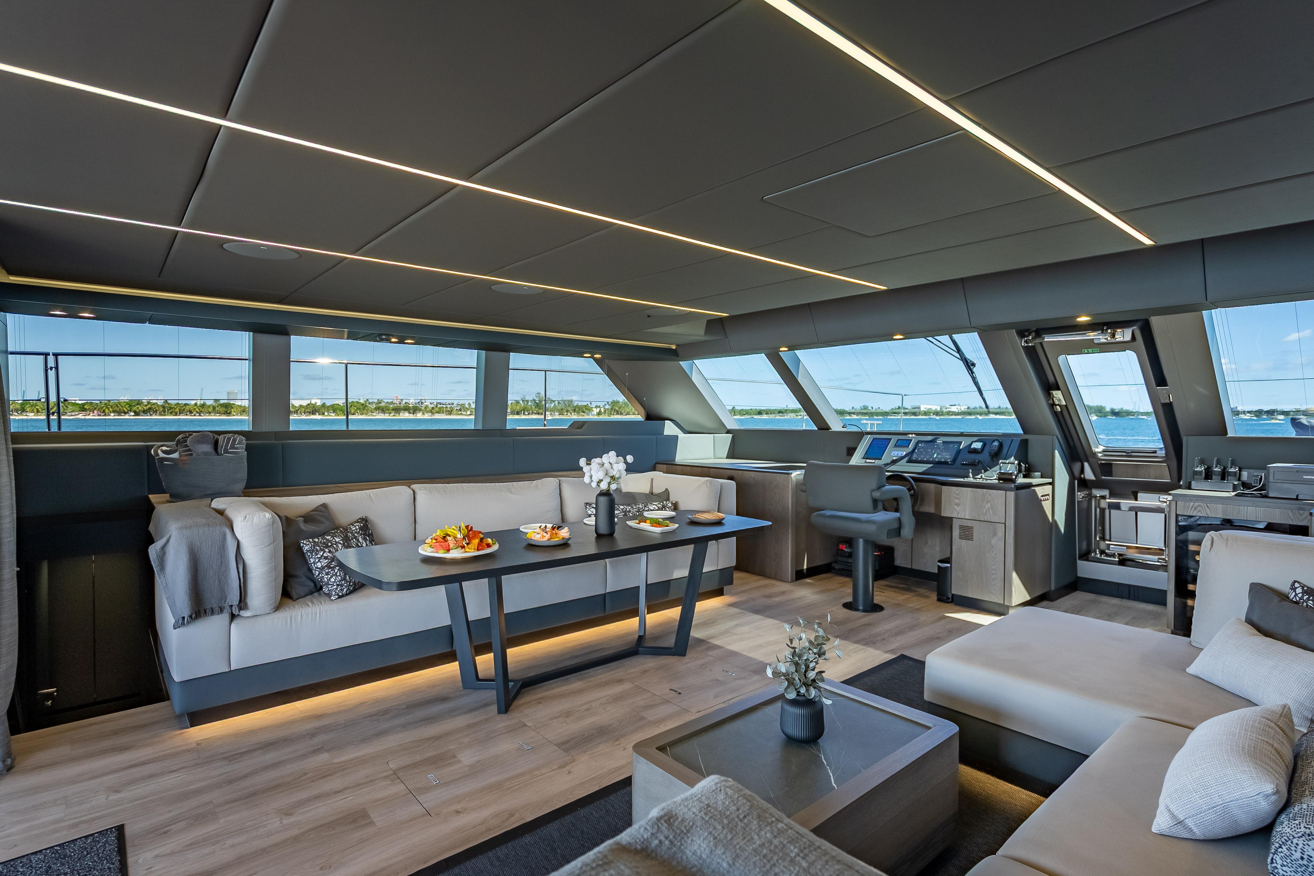 Luxurious interior of 2026 Sunreef 60 Power yacht with modern furnishings and panoramic windows.