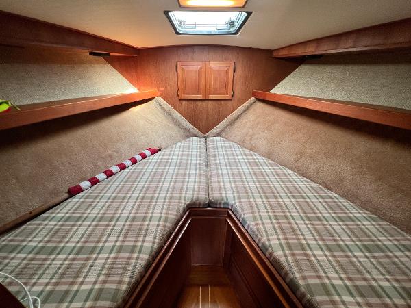 Interior of the 1985 Viking 35 Express with cozy sleeping area and wood paneling.