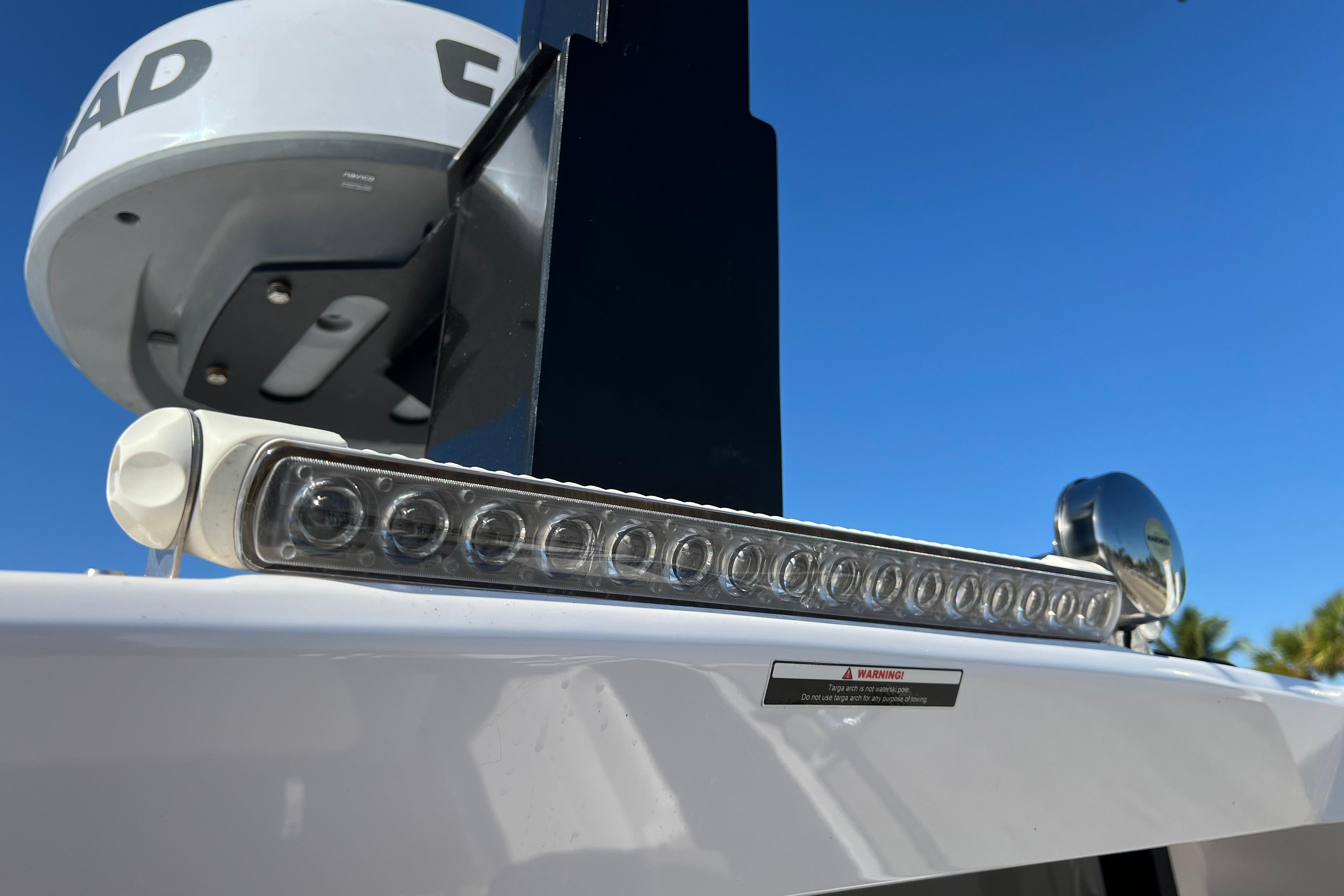 2024 XO Boats EXPLR 10 S Plus radar and light detail against blue sky.