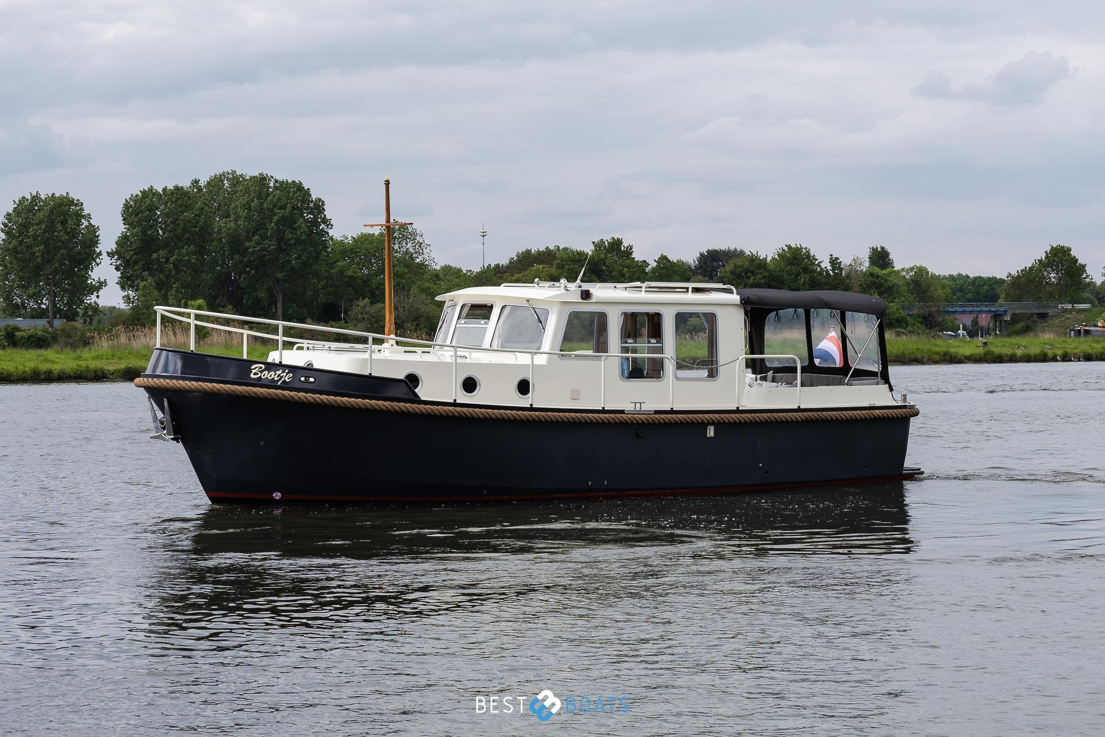 2004 Vripack 965 OK boat cruising on a calm river with lush greenery.