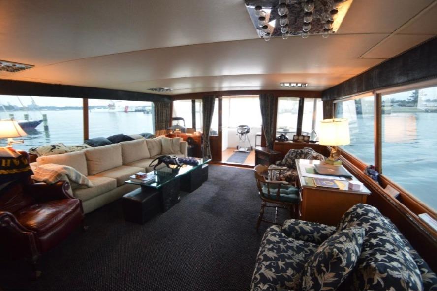 Luxurious interior of a 1974 Pacemaker Cockpit Motoryacht with elegant seating and waterfront views.
