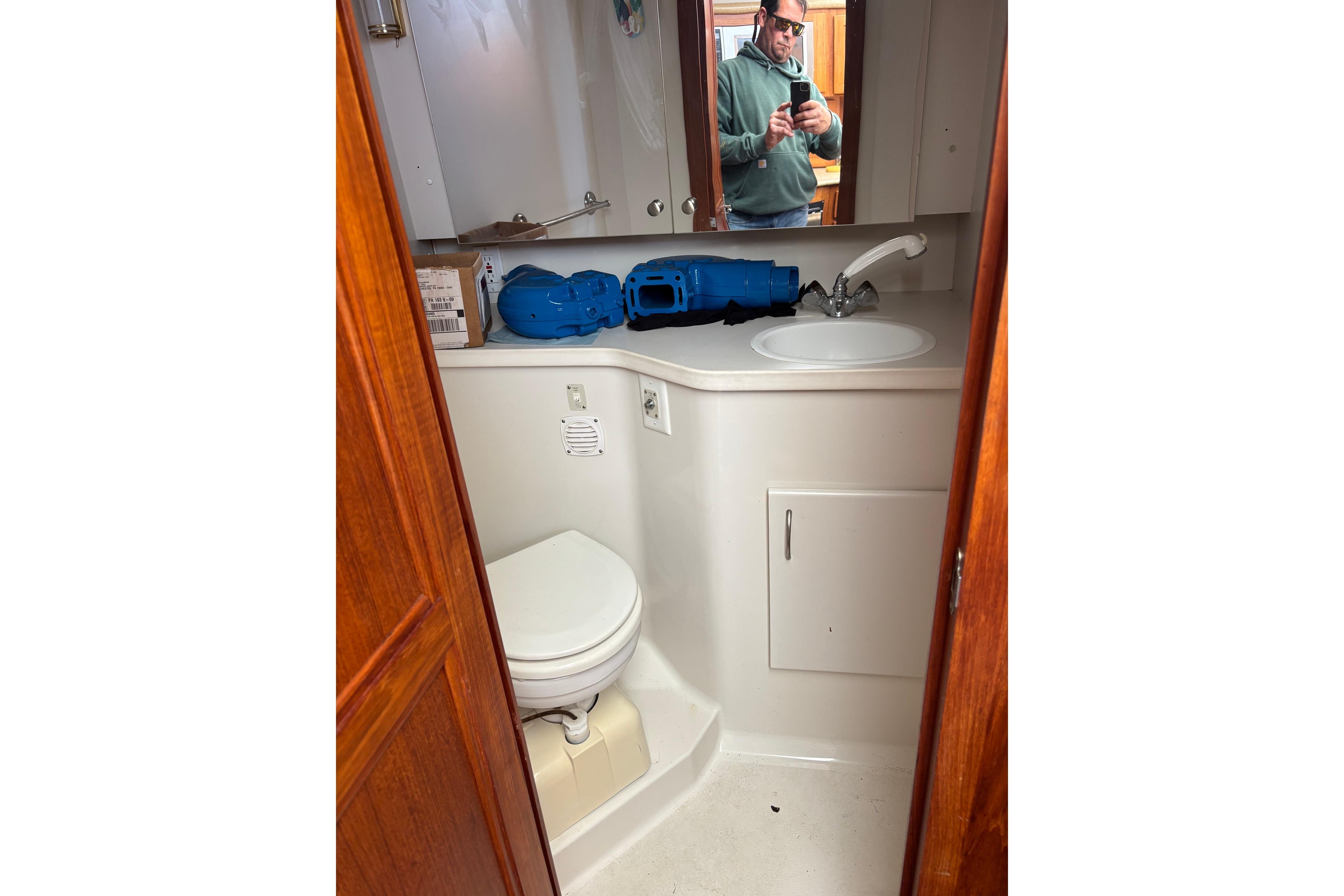 Bathroom interior of 1995 Carver 356 Aft Cabin Motor Yacht with sink and toilet.