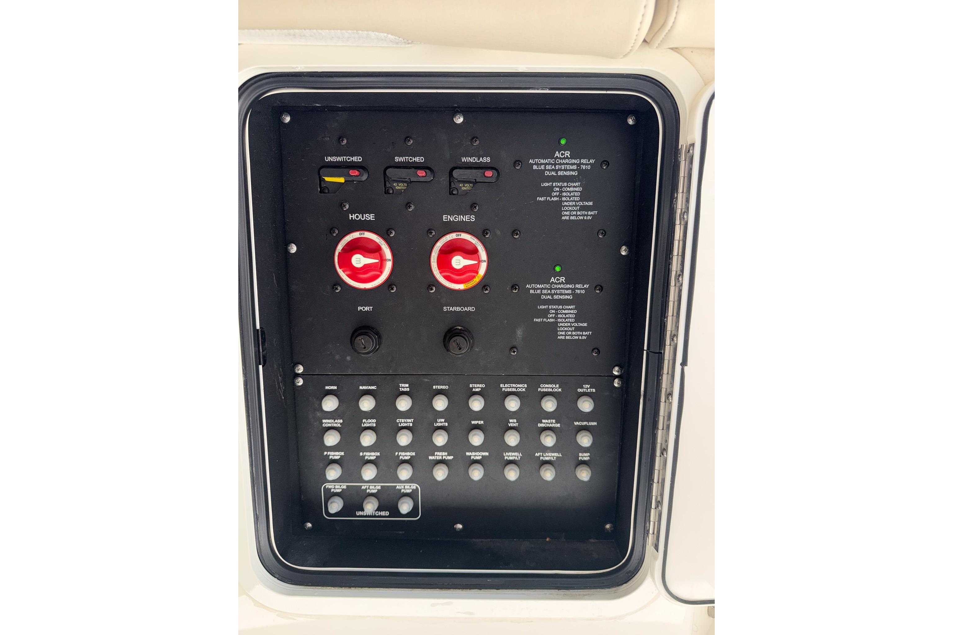 Control panel of a 2021 Boston Whaler 330 Outrage boat, featuring switches and dials.