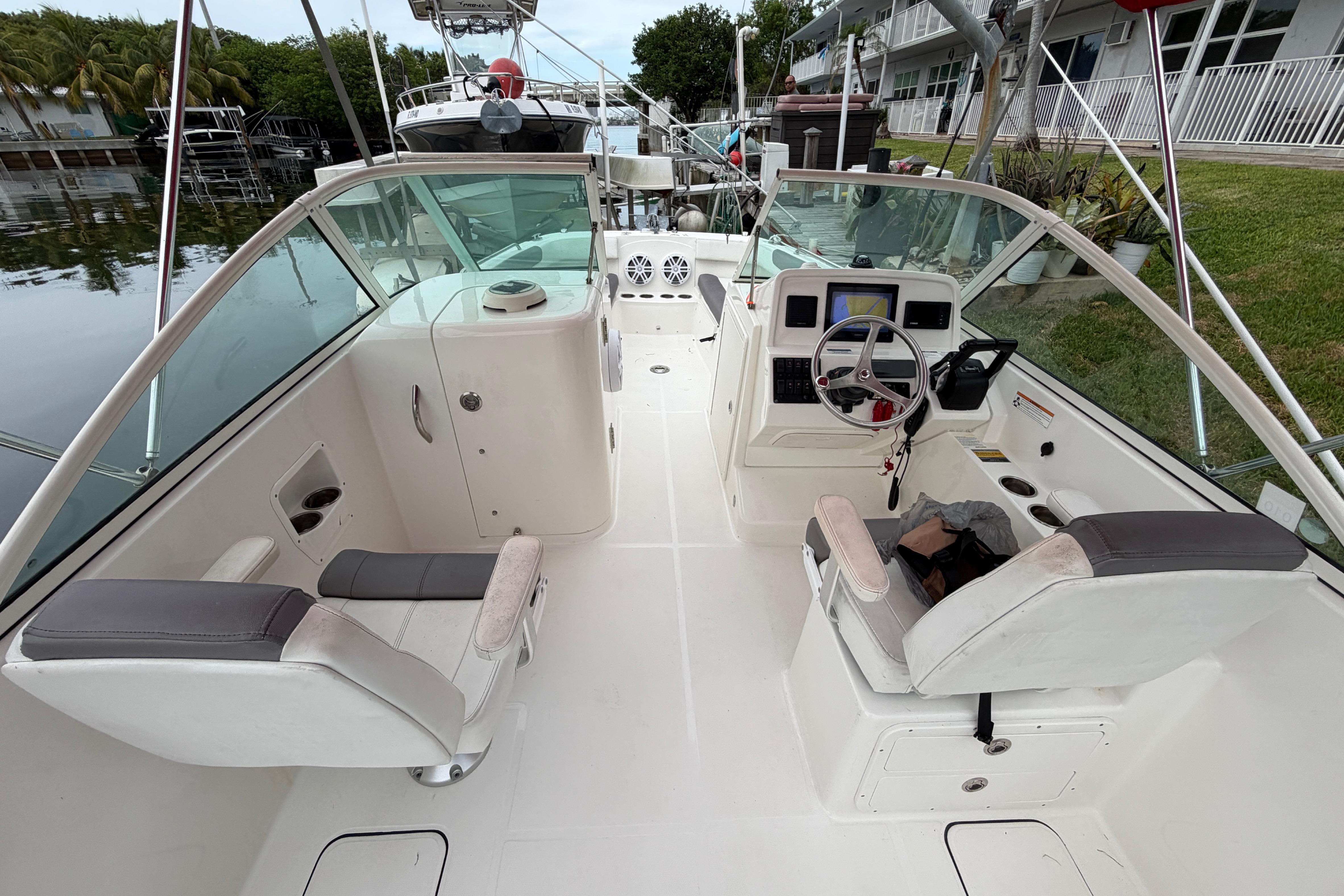 2019 World Cat 230 DC boat interior with dual console seating and steering wheel.