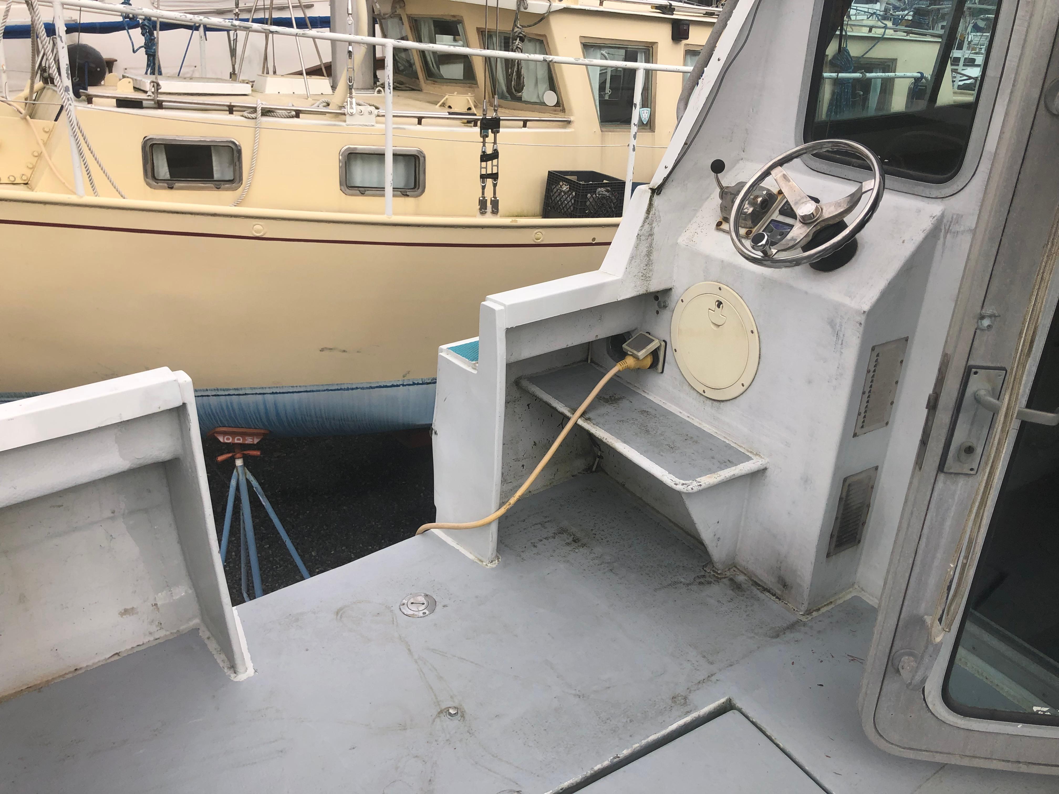 1996 Martin Trunk Cabin boat interior with steering wheel and docked vessel in background.