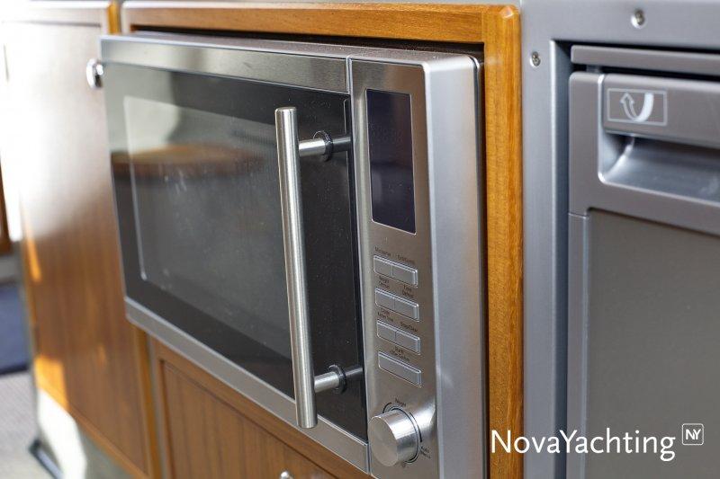 Built-in microwave in a 2017 Sargo 36 yacht kitchen, featuring stainless steel finish.