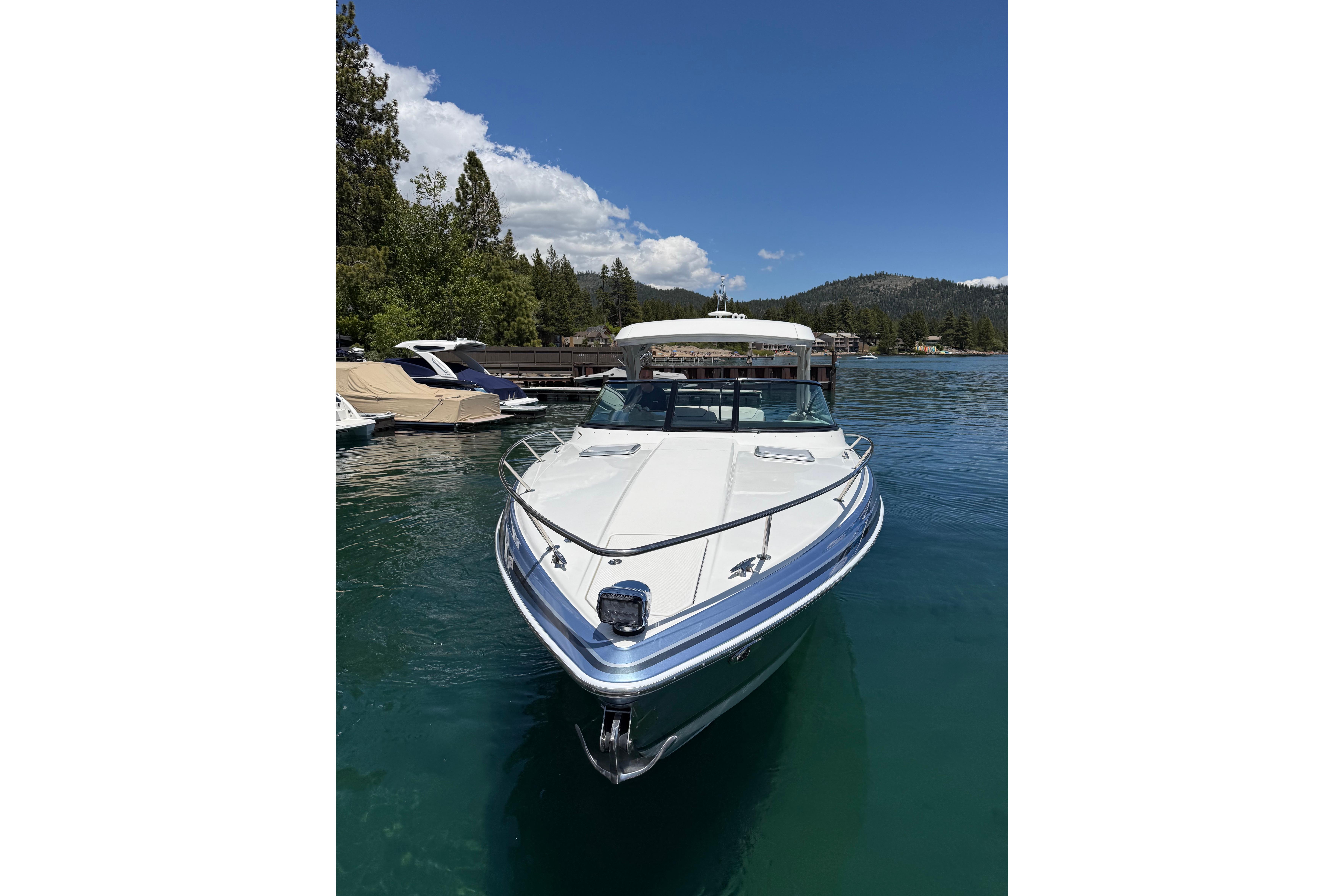 2021 Formula 350 Sun Sport boat docked on a serene lake with clear skies.