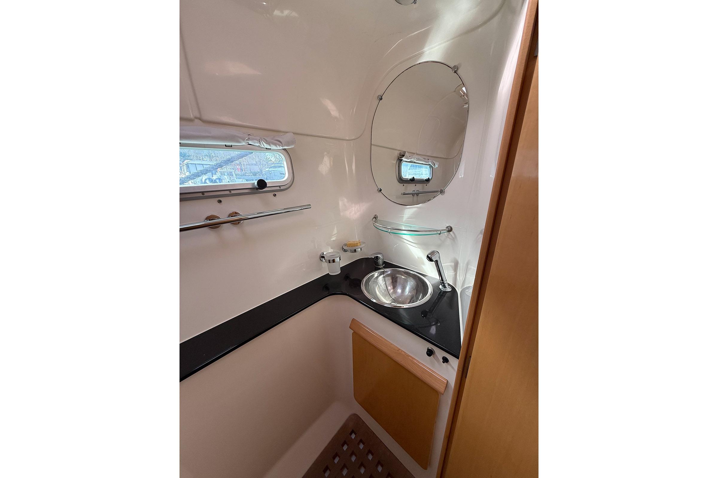 Bathroom interior of 2007 Alliaura Privilege 495 yacht with sink and mirror.